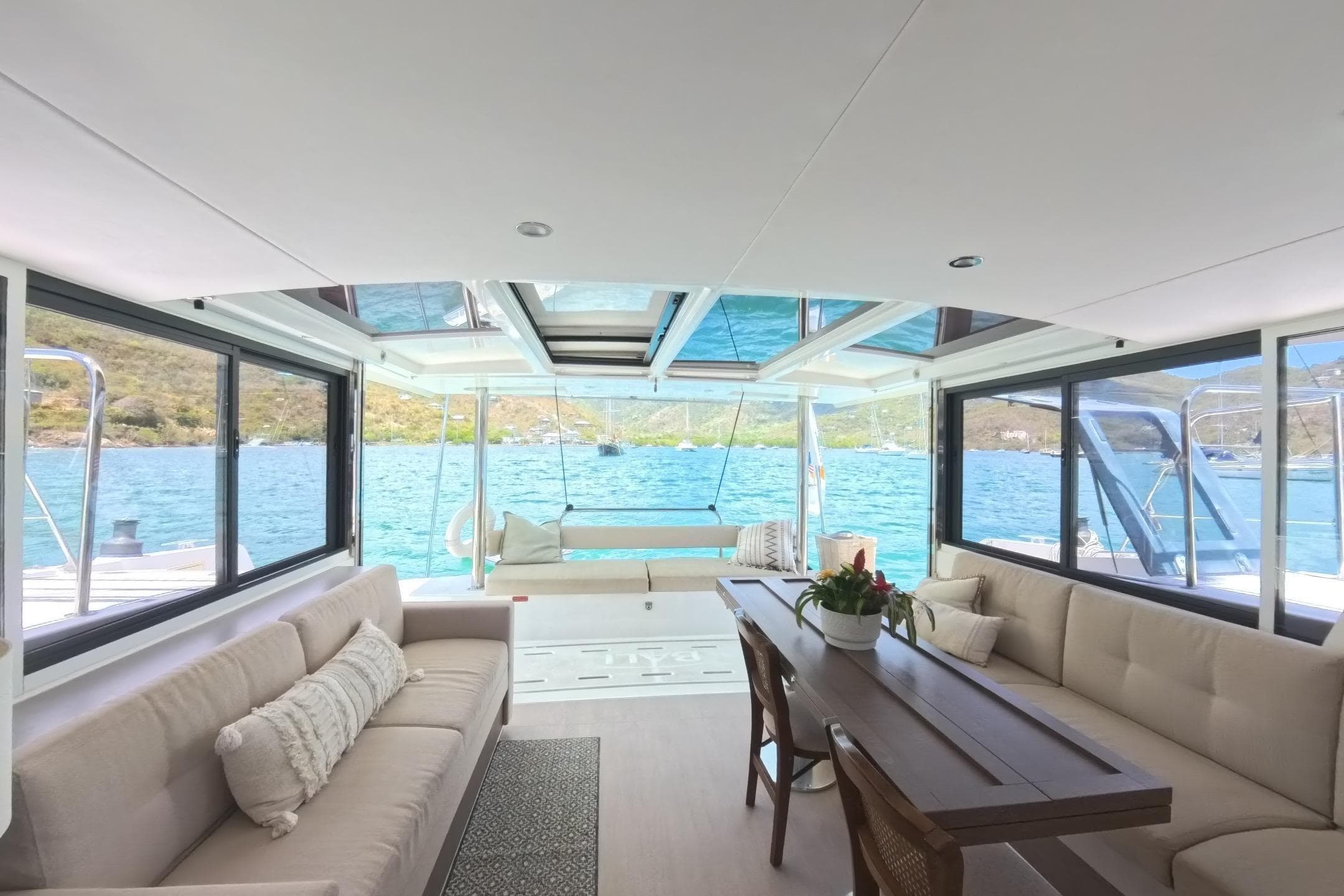 Luxurious interior of 2022 Bali 4.6 yacht with panoramic windows and elegant seating.