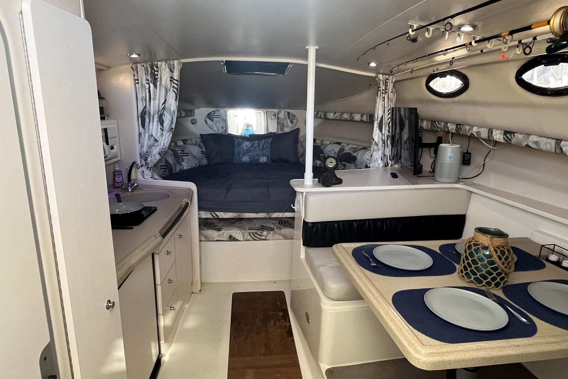 Interior of 2001 Wellcraft 330 Coastal boat with cozy bed and dining area.