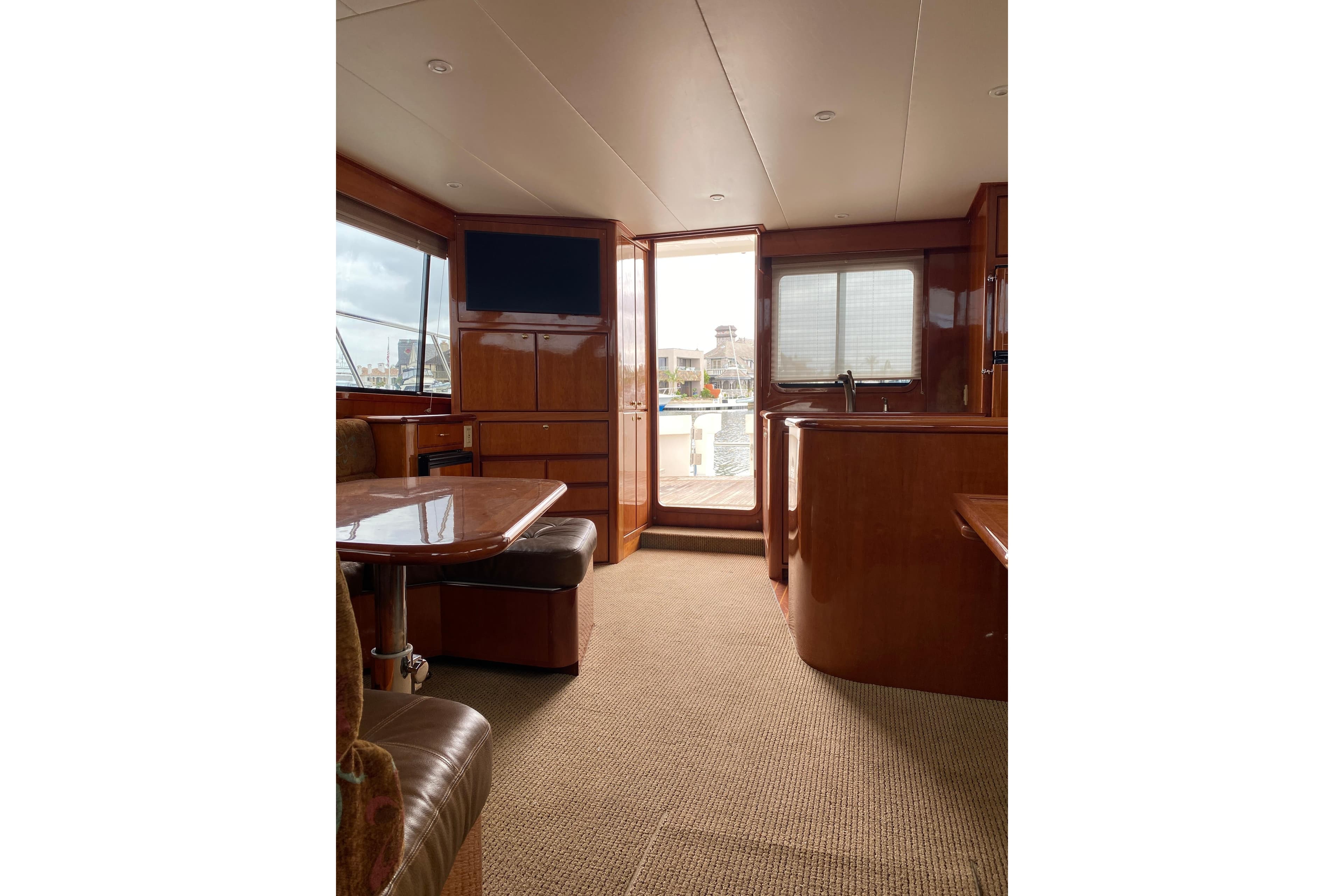 Interior of 2012 Mikelson 43 Sportfisher yacht with wood finish and seating area.