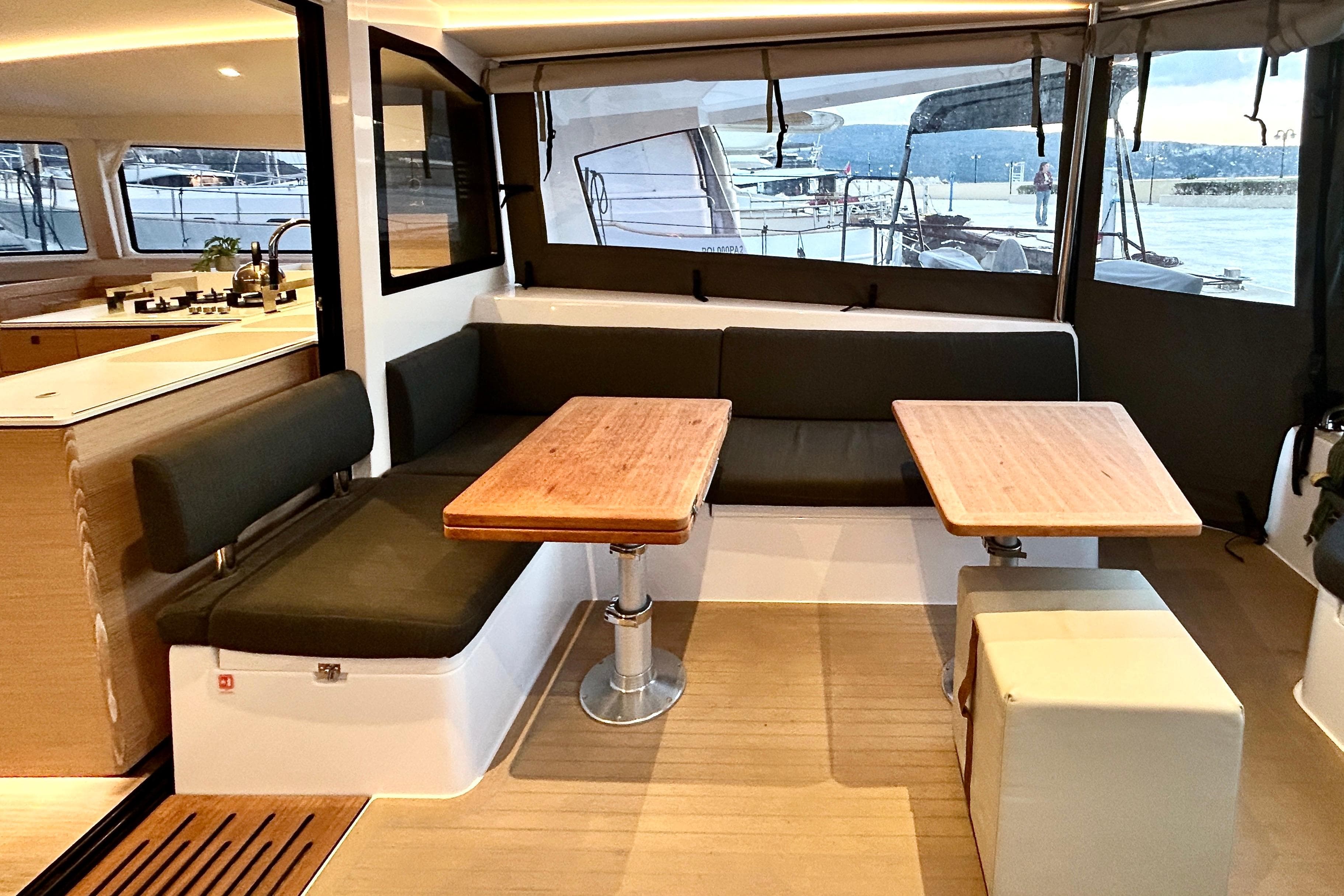 2025 Nautitech 44 Open yacht interior with modern seating and dual tables.