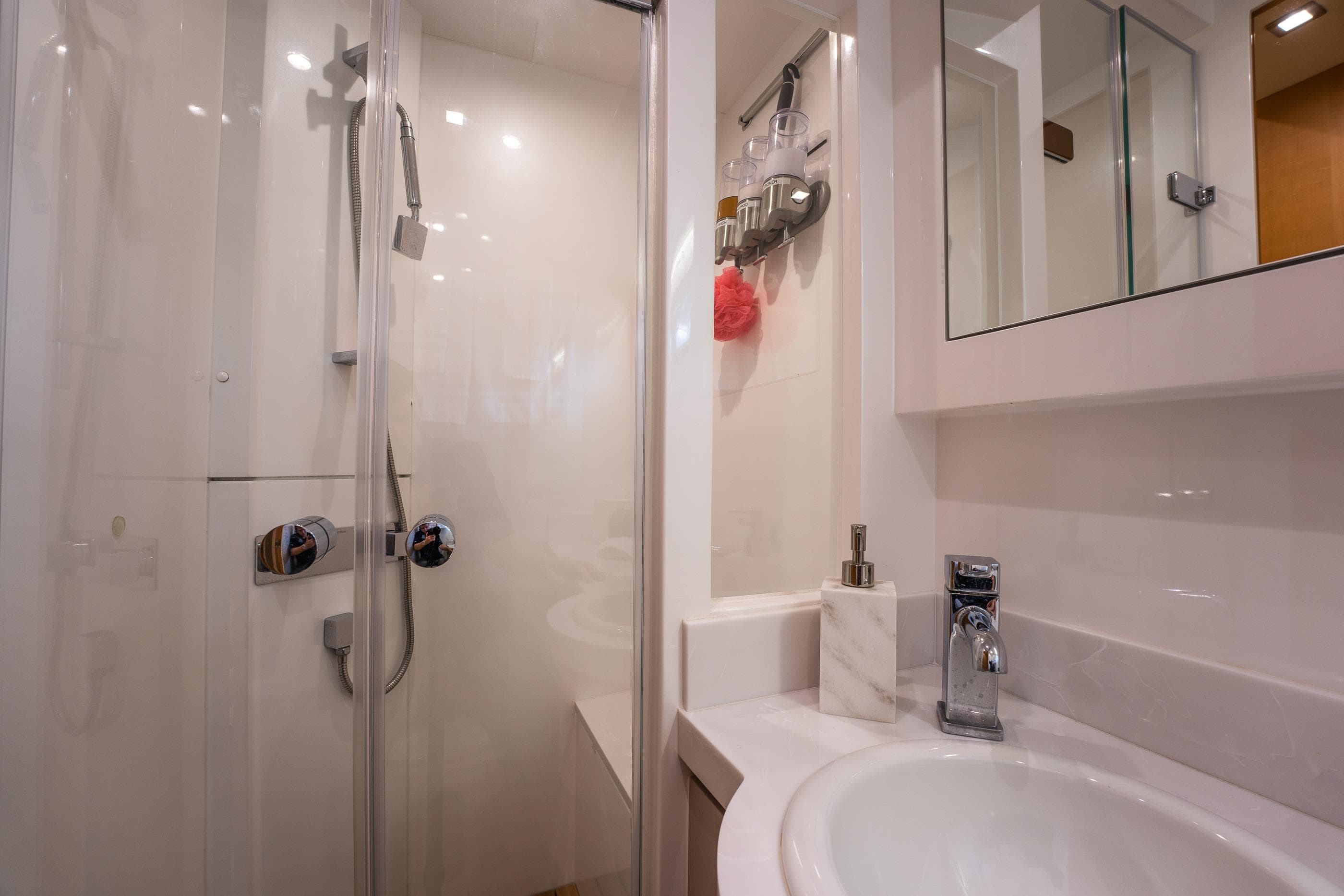 Modern bathroom in 2013 Horizon PC60 yacht with shower and sink.
