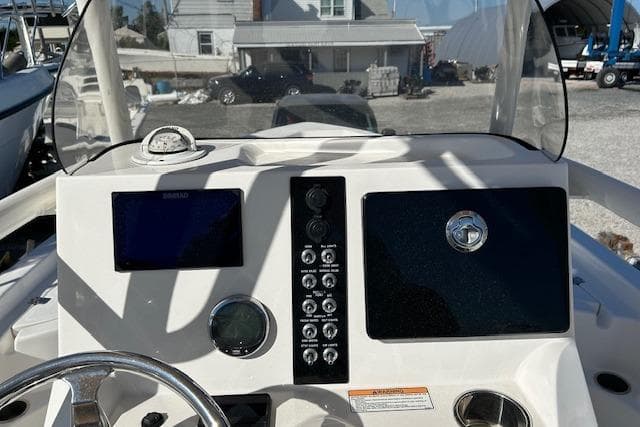 2023 NauticStar 227 XTS boat dashboard with steering wheel and control panel.