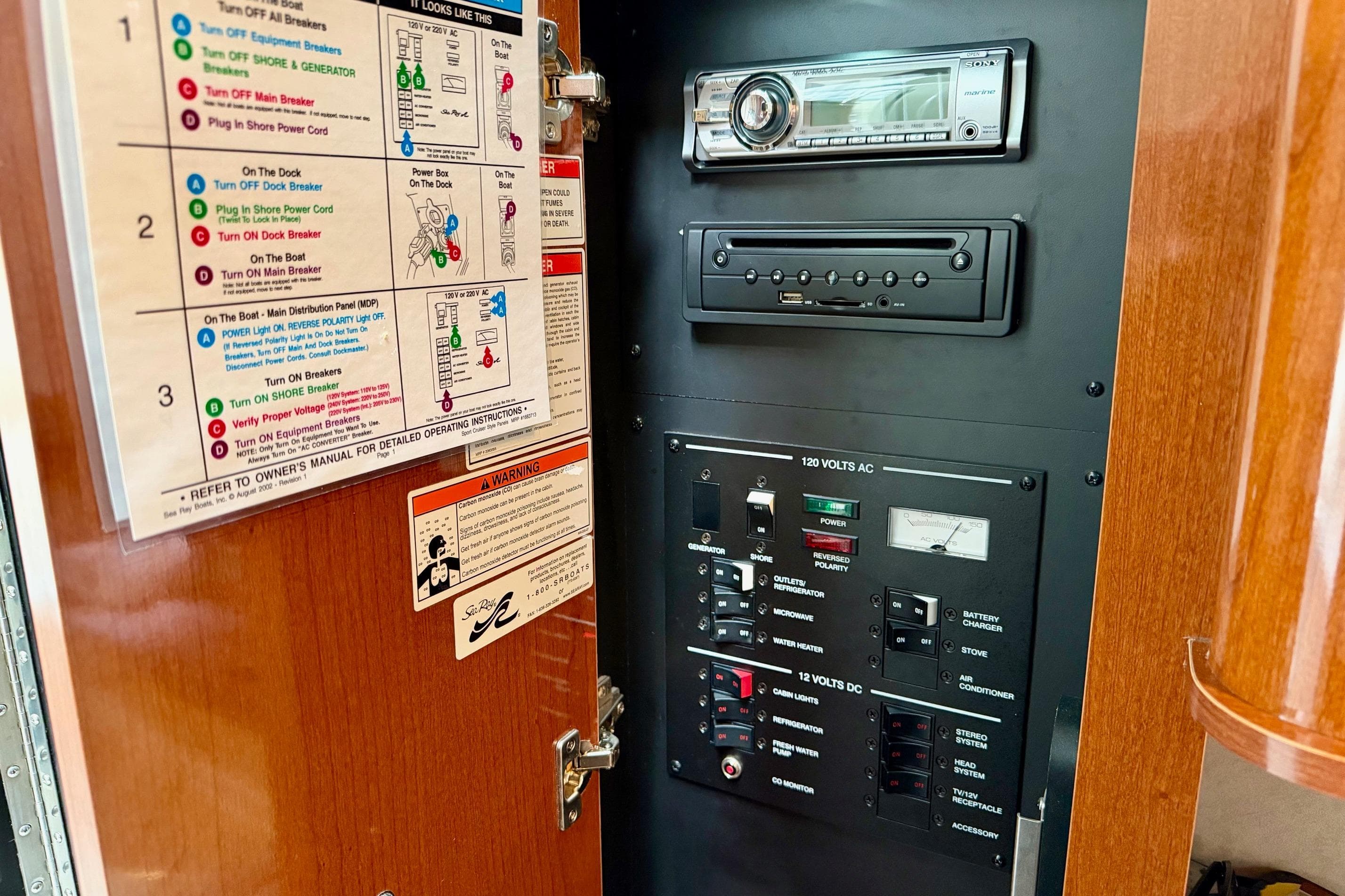 Control panel of a 2012 Sea Ray Sundancer 280 boat with stereo system and circuit breakers.