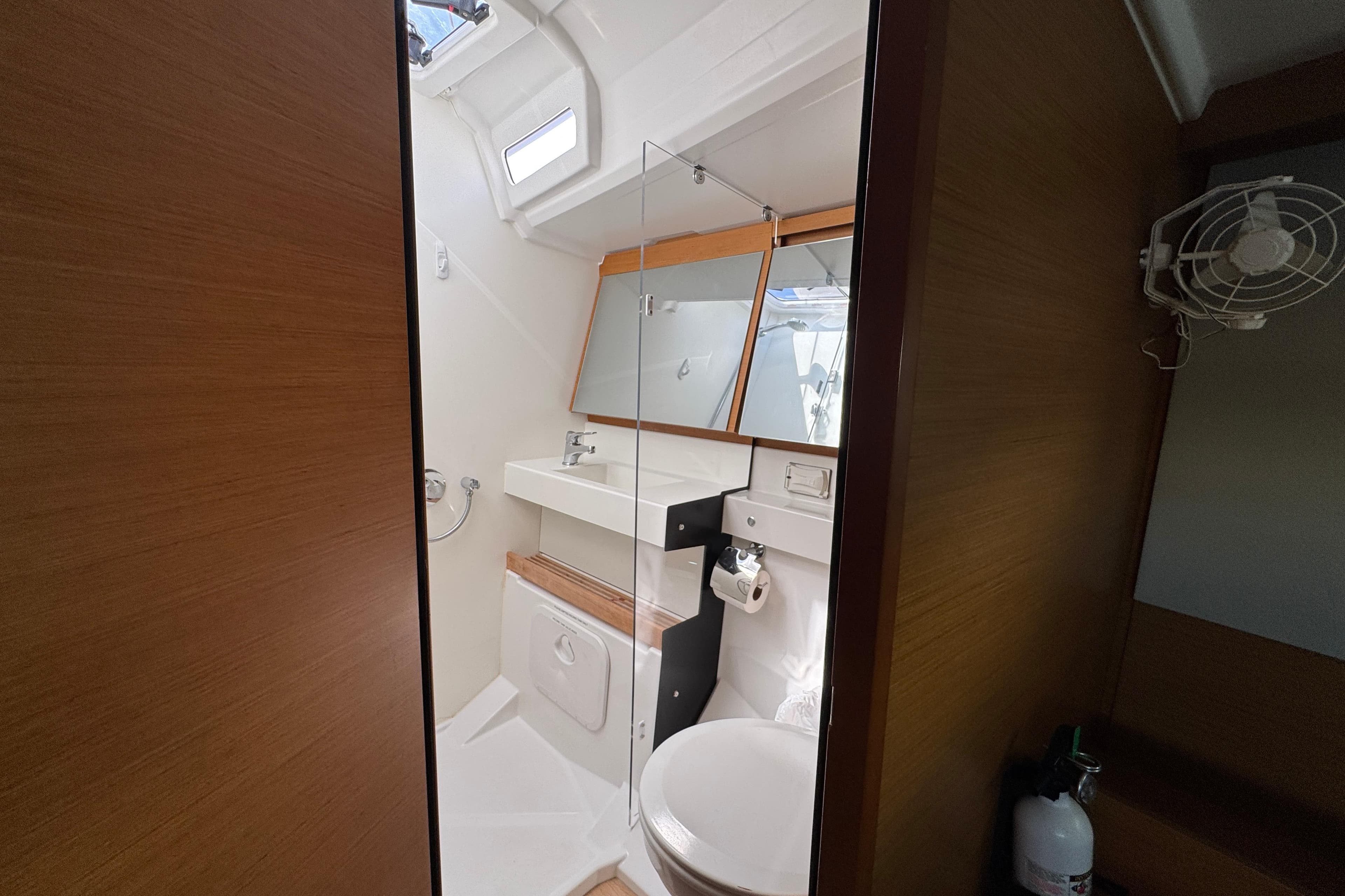 Bathroom interior of 2018 Jeanneau Sun Odyssey 440 yacht, featuring modern fixtures and wooden accents.