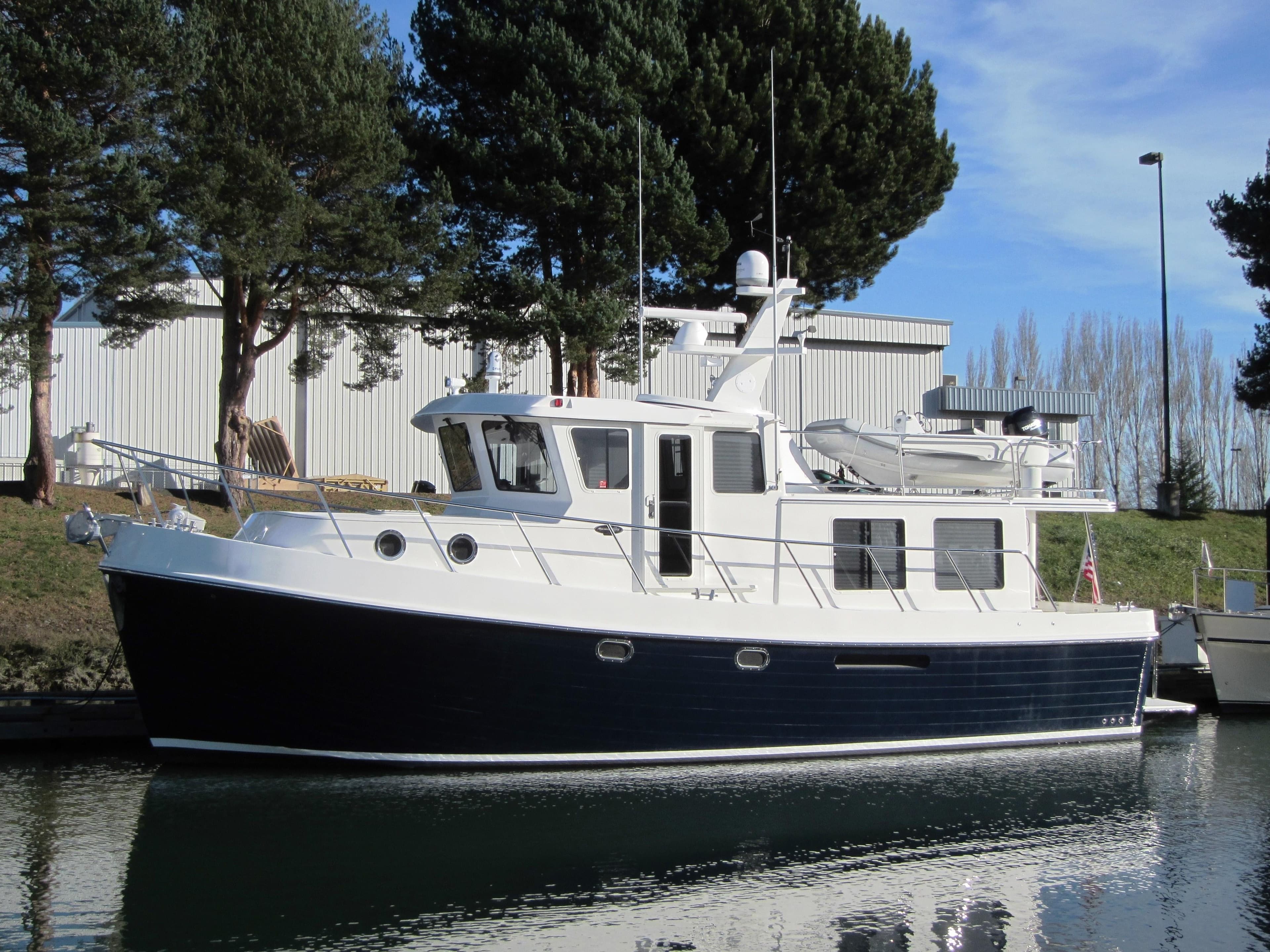 2025 American Tug 435 model docked in a serene marina.