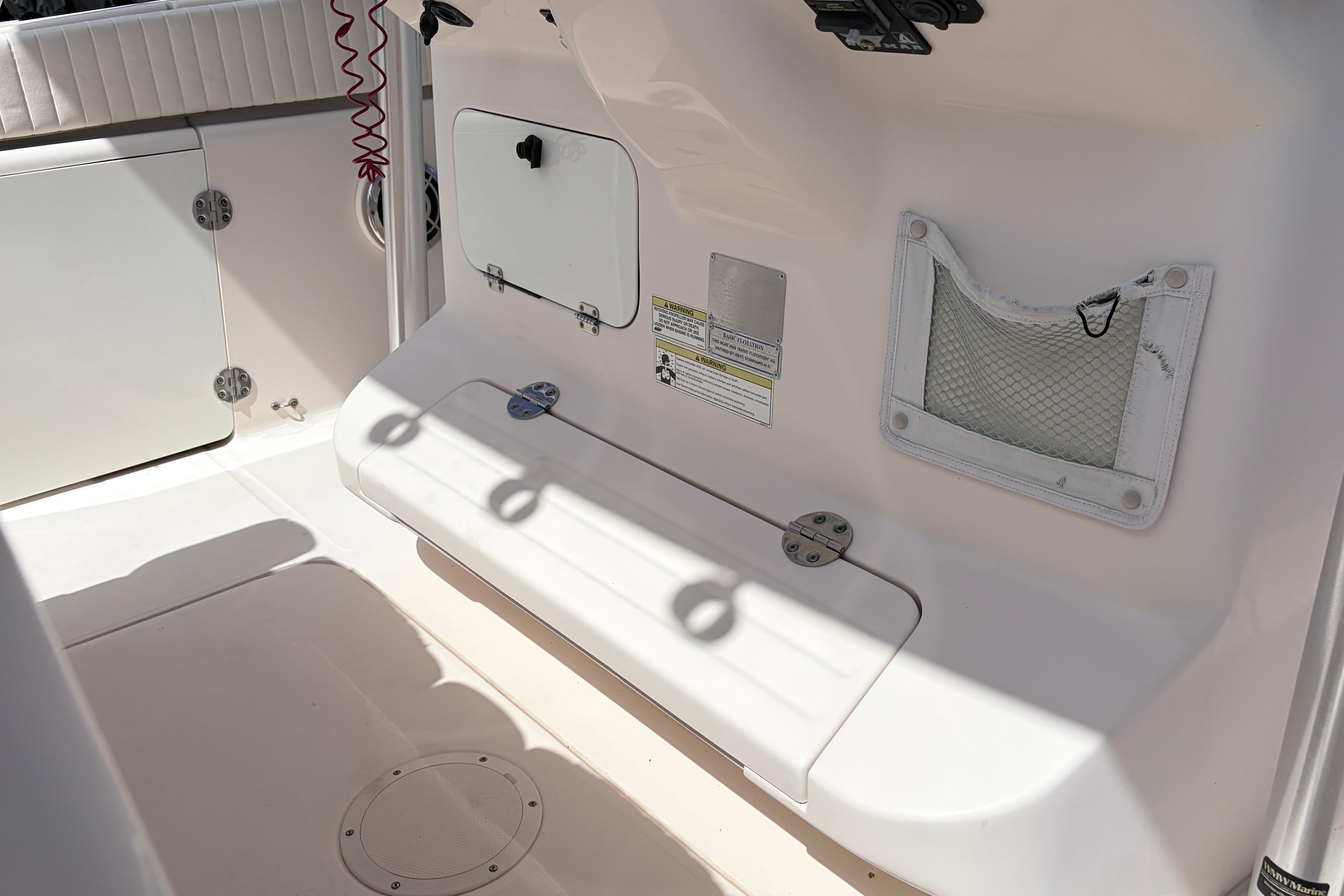 2014 Grady-White Canyon 283 boat interior with storage compartments and seating area.