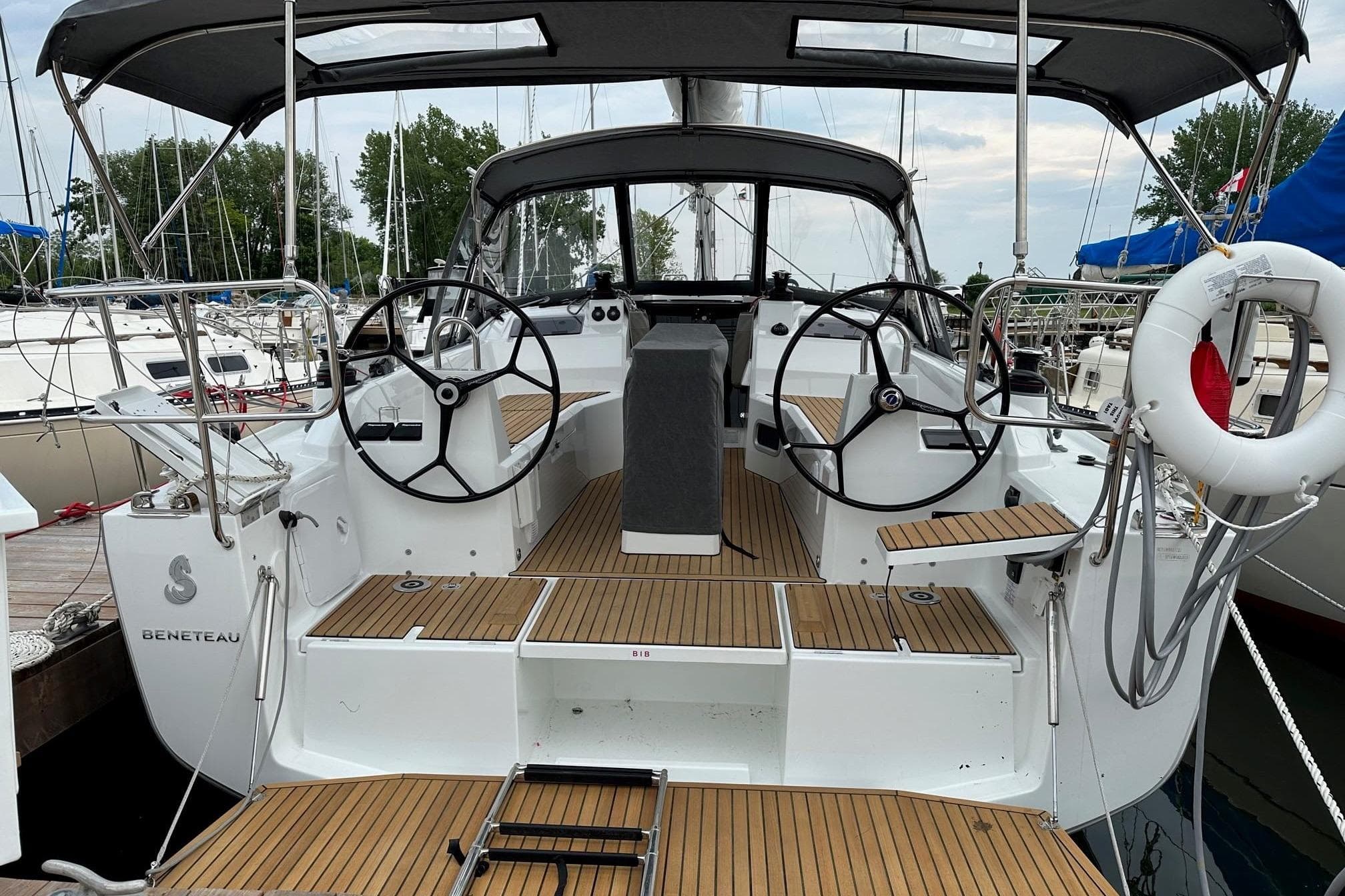 2023 Beneteau Oceanis 34.1 sailboat cockpit with dual steering wheels and teak decking.