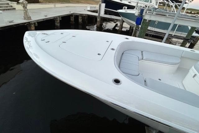2025 Contender 26 Bay boat docked, showcasing sleek design and spacious deck.
