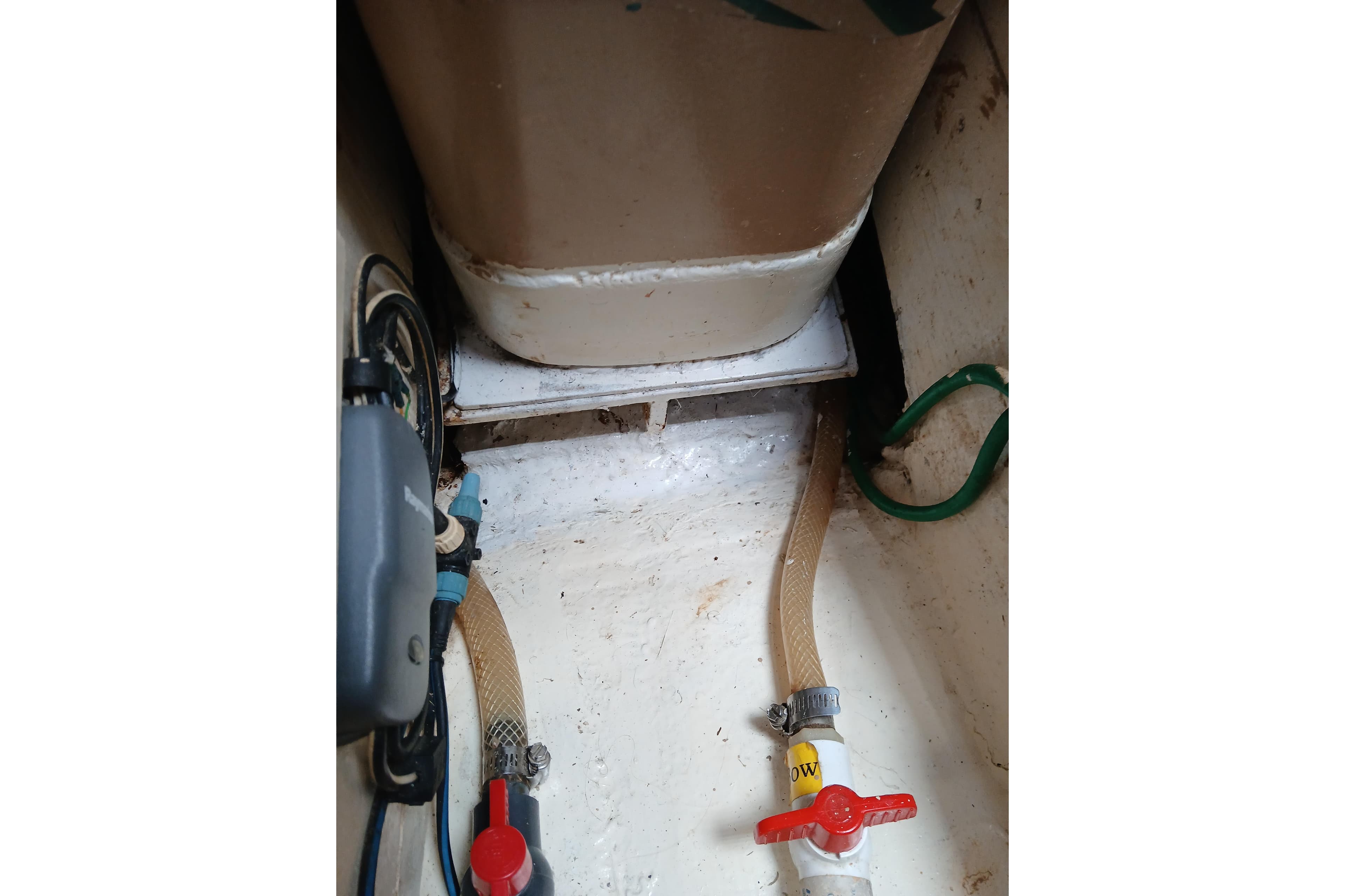 Interior of 1977 Ericson 36 C sailboat showing plumbing and storage area.