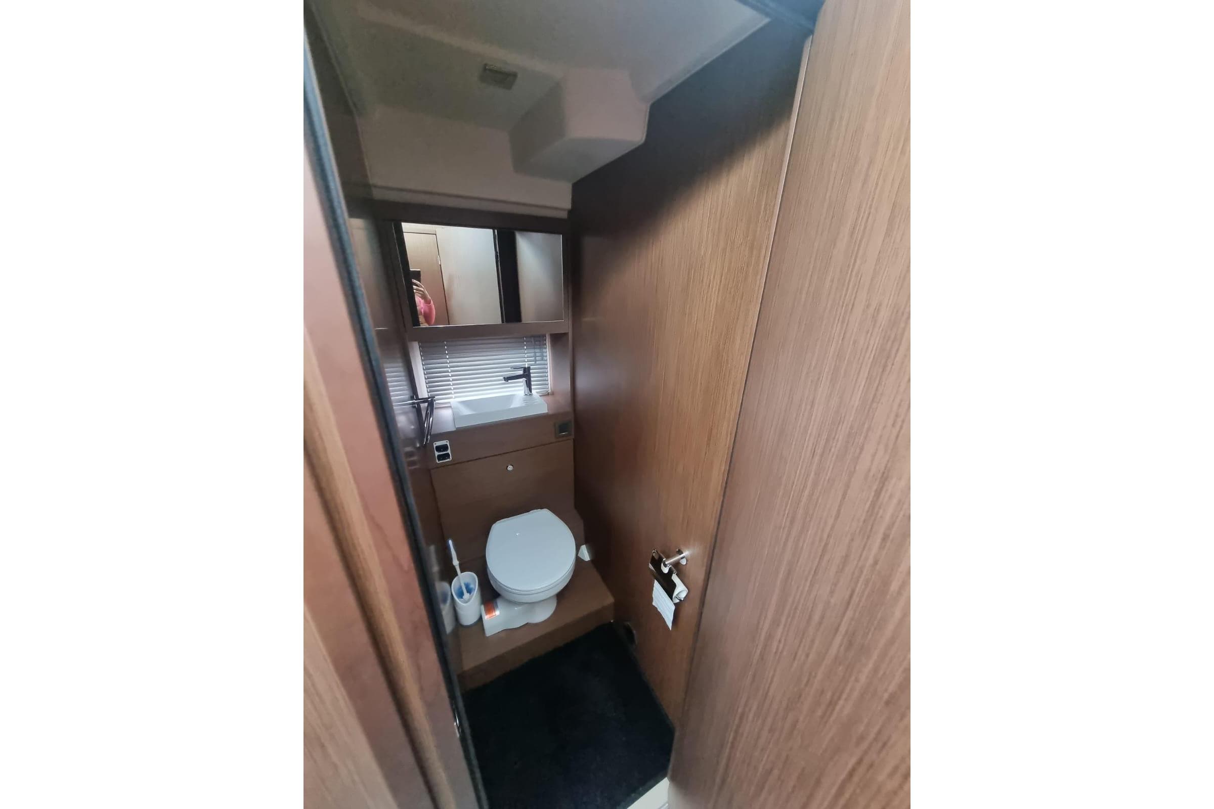 2023 Jeanneau NC 37 bathroom interior with wooden finish and modern fixtures.