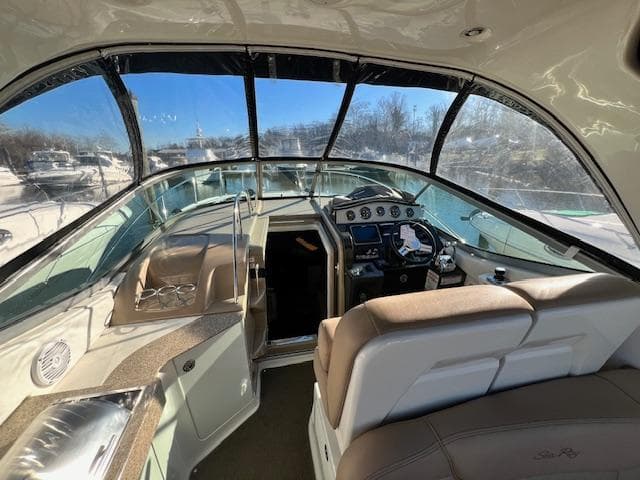Interior view of 2017 Sea Ray 330 Sundancer yacht cockpit with steering wheel and seating.