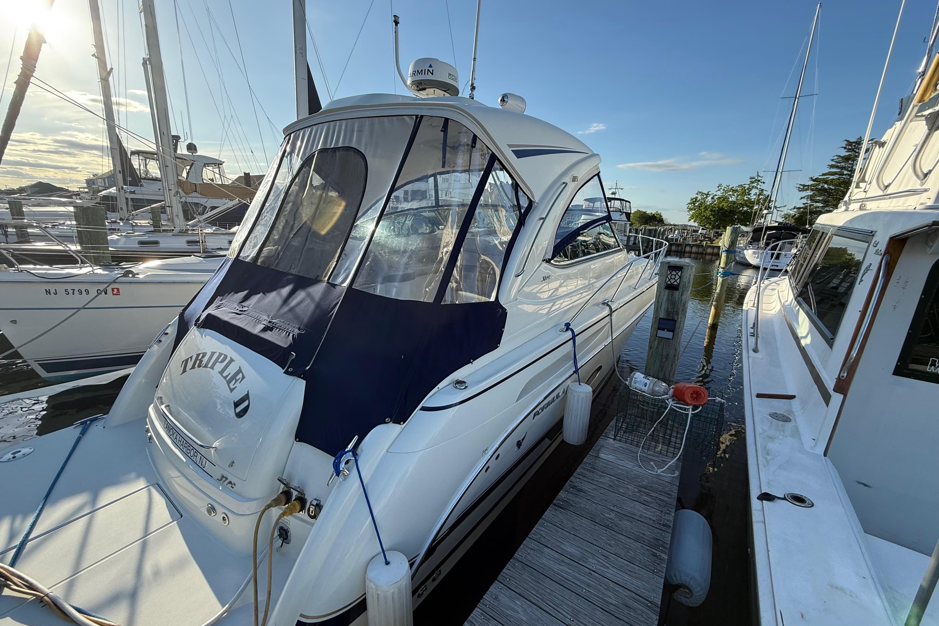 2016 Formula 37 Performance Cruiser docked at marina, sunny day.