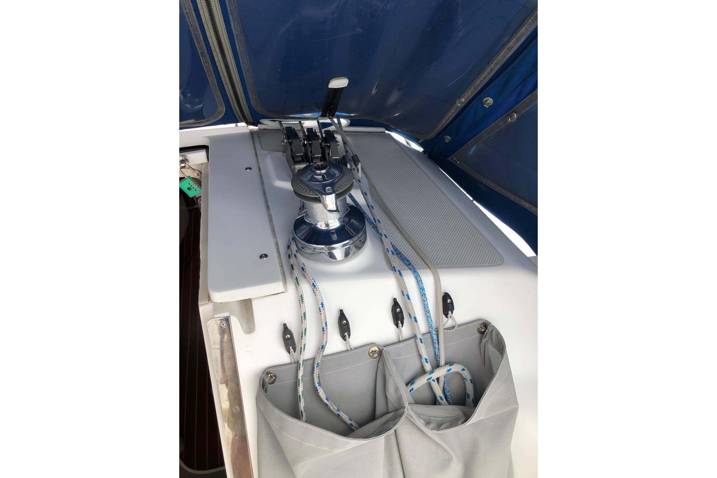 Cockpit of 1998 Catalina 320 sailboat with winch and ropes.