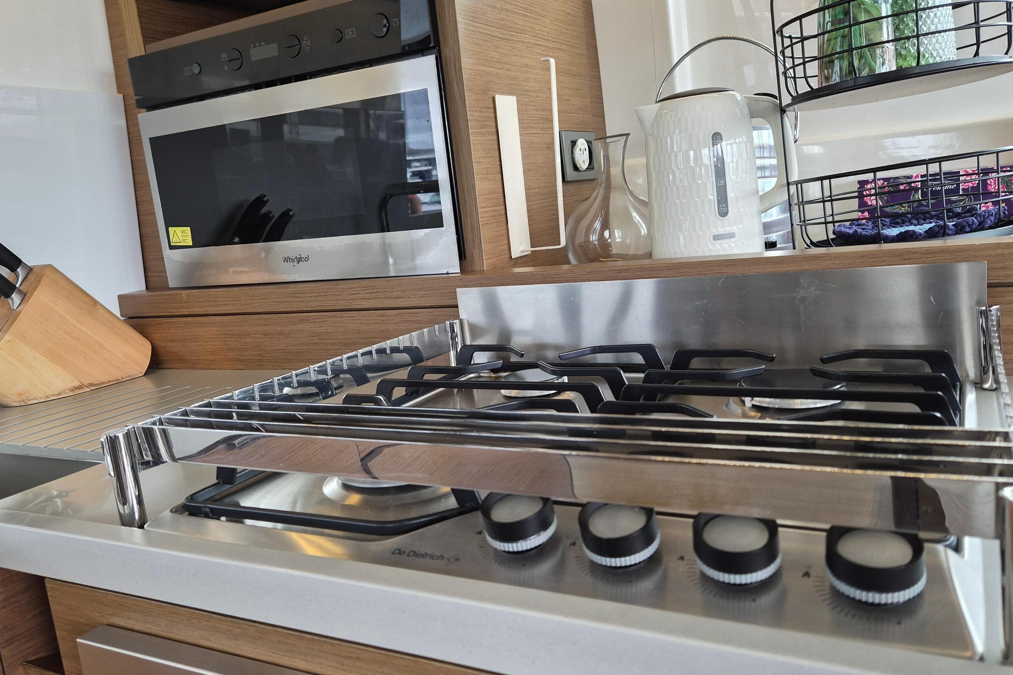 Modern kitchen in 2021 Lagoon 50 yacht with stove, oven, and kettle.
