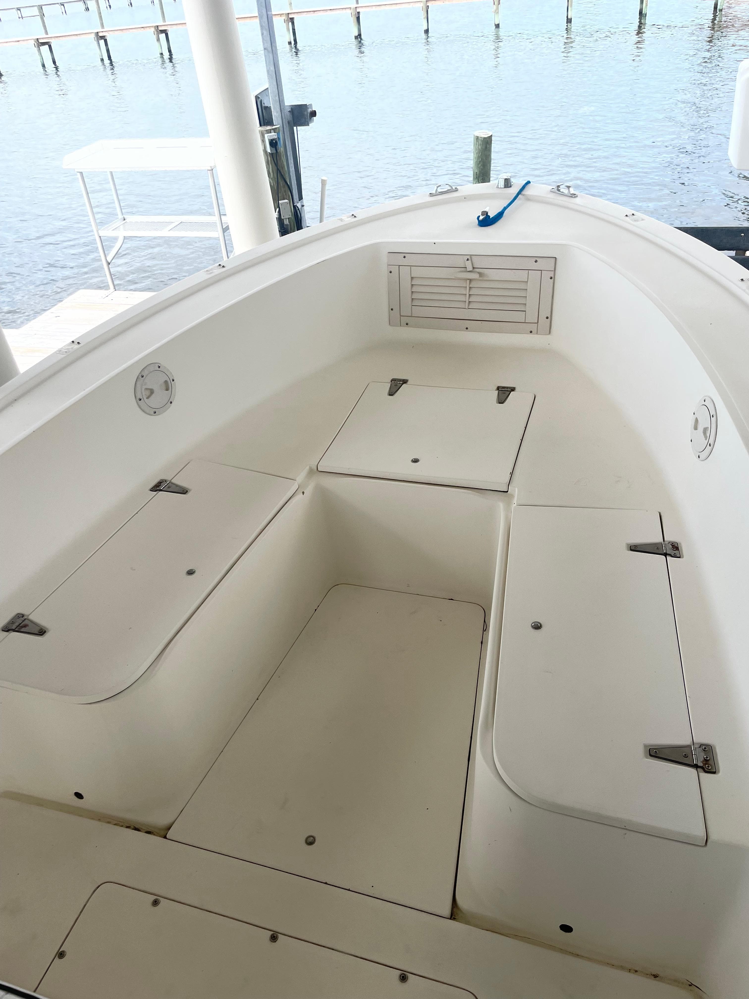 1992 Mako 221 CC boat interior with storage compartments, docked by the water.