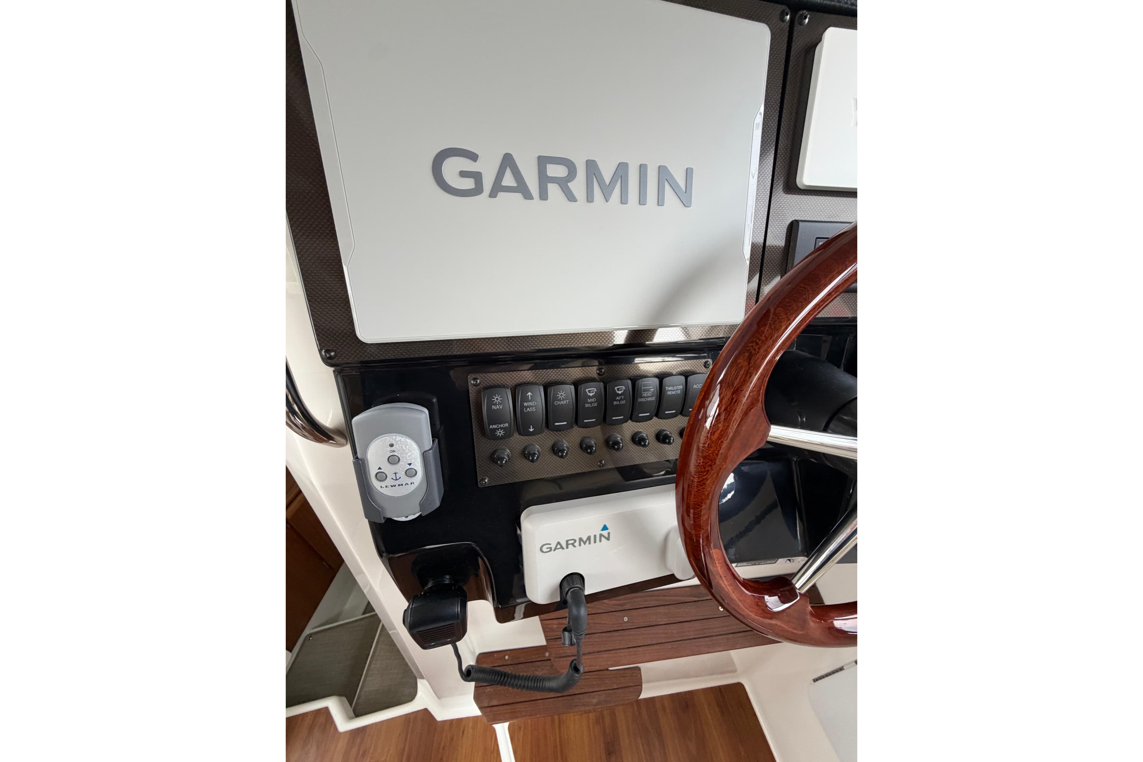 Helm of 2026 Cutwater C-288 CB with Garmin navigation system and wooden steering wheel.
