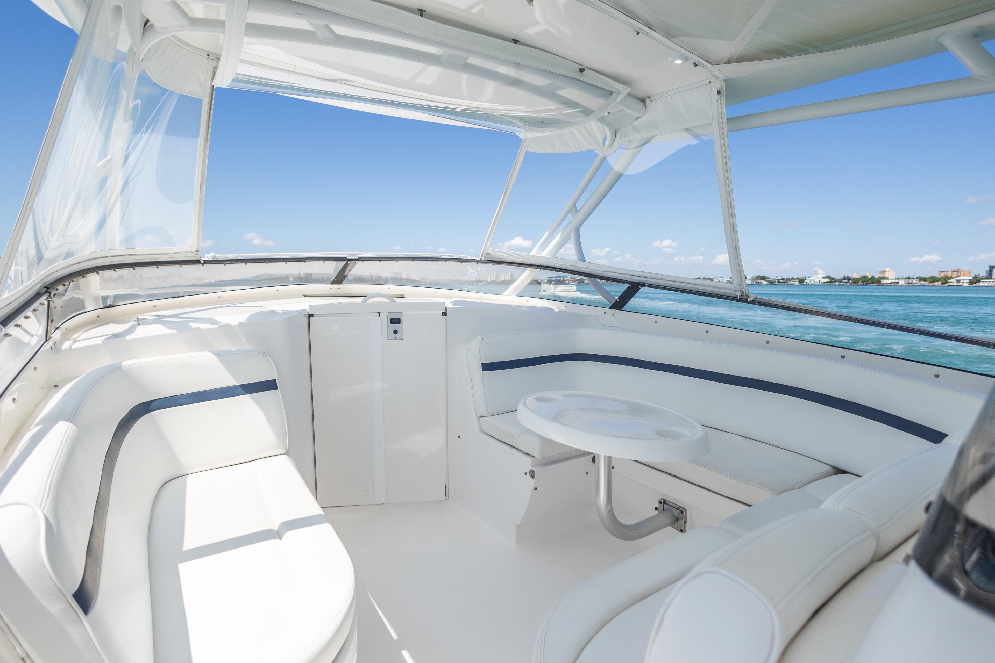2014 Intrepid 400 Cuddy interior with white seating and ocean view.