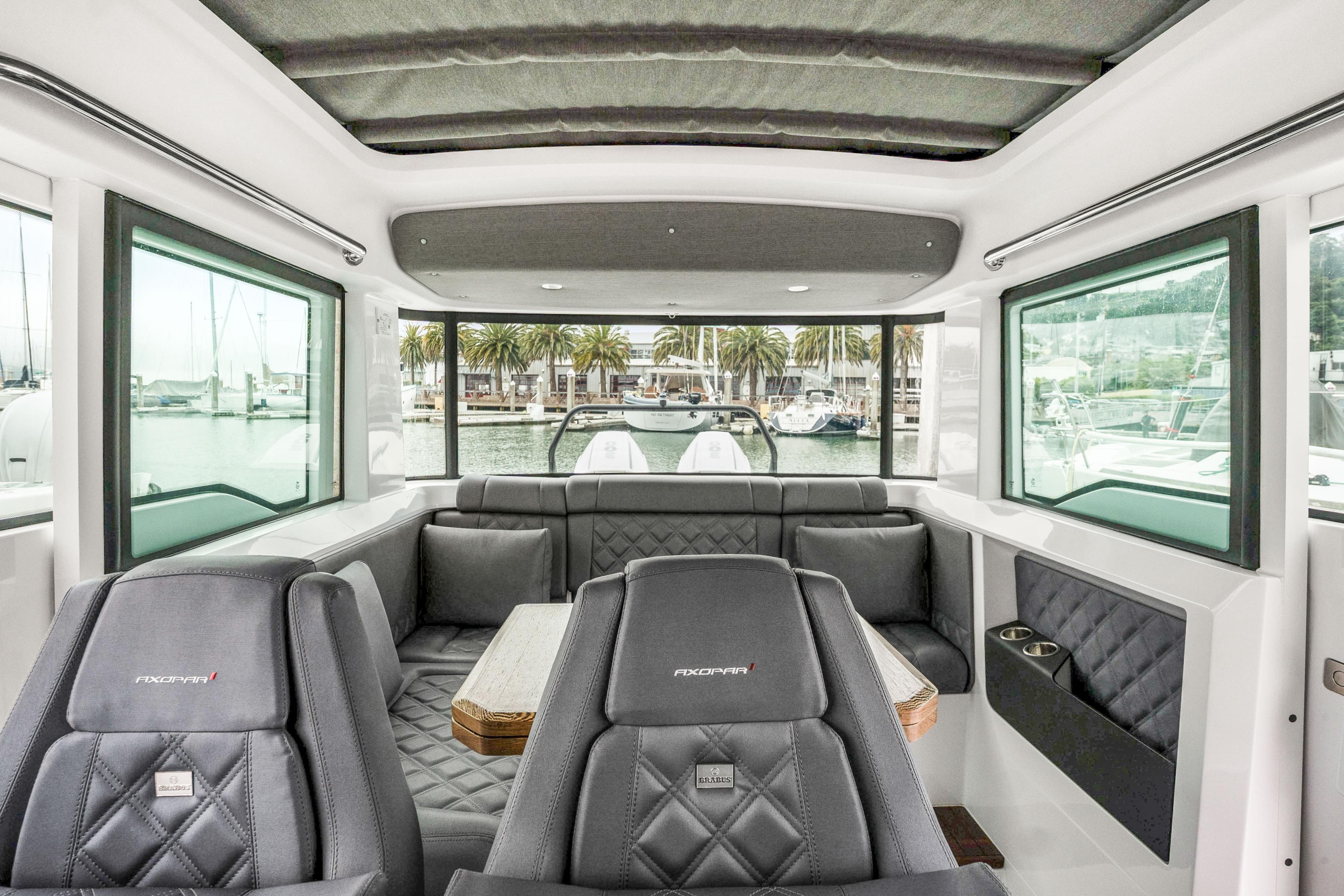 Interior of 2021 Axopar 37 XC Cross Cabin with luxurious seating and panoramic windows.