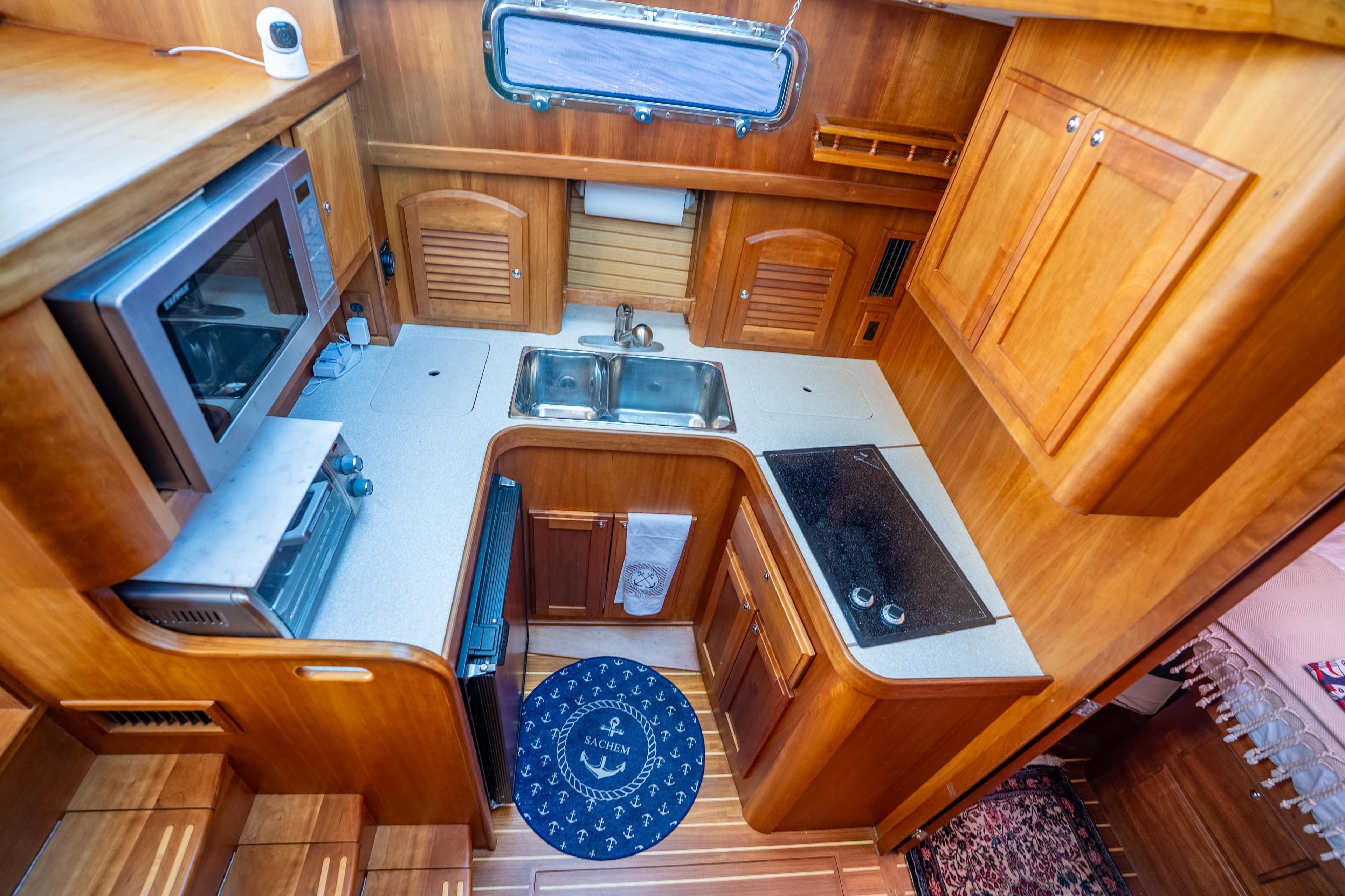 Compact kitchen in 2006 Sabreline 36 Fly yacht with wood cabinetry and modern appliances.