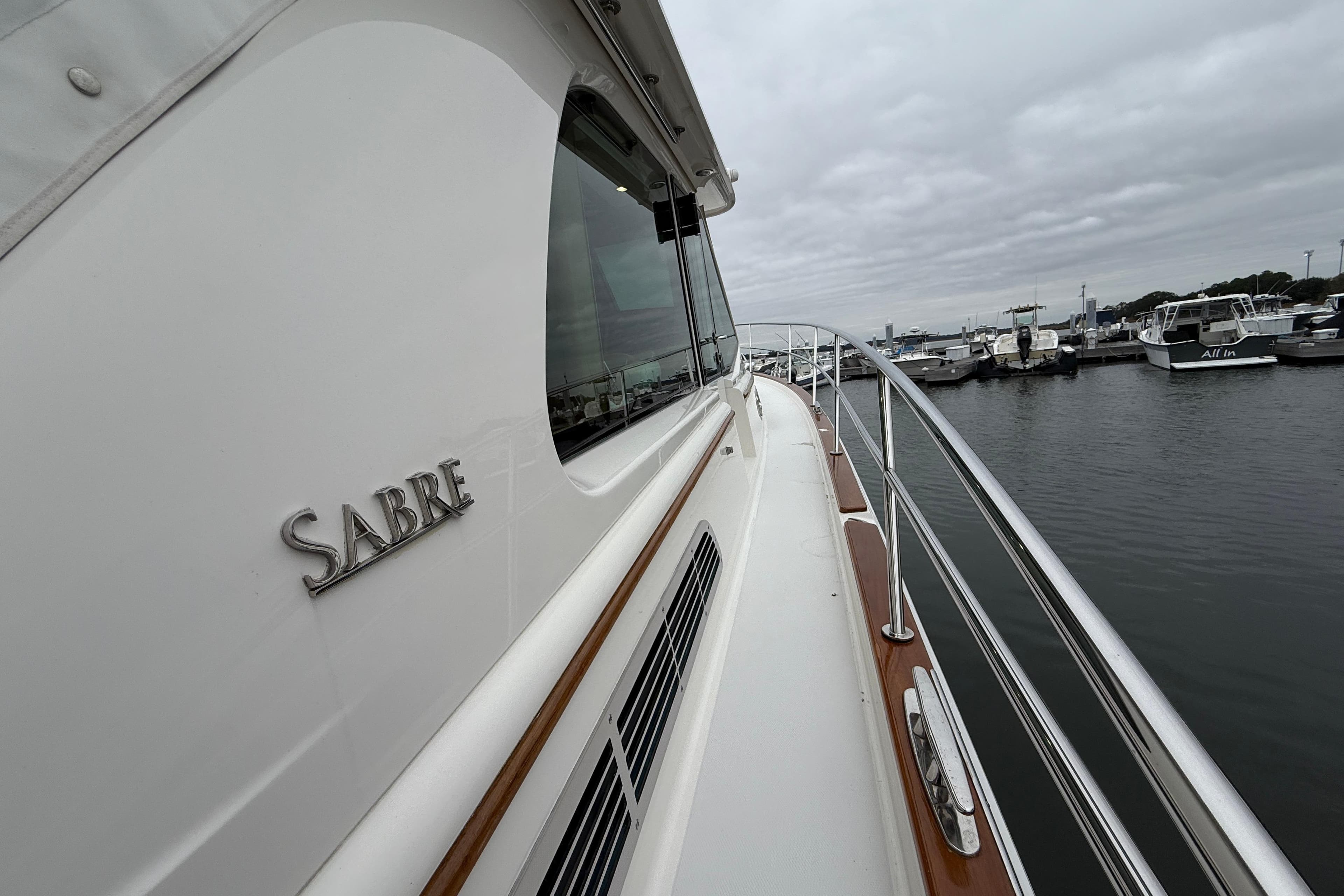 2023 Sabre 43 Salon Express yacht docked at marina, showcasing sleek design and craftsmanship.
