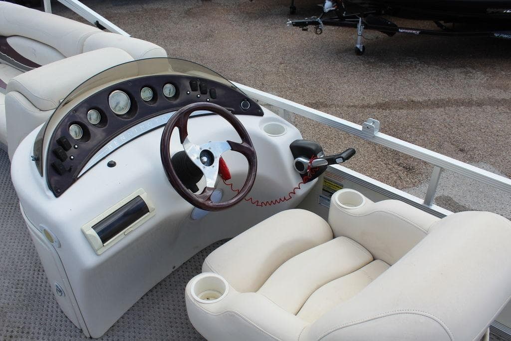 2005 Bennington 2275 RL boat dashboard with steering wheel and gauges.