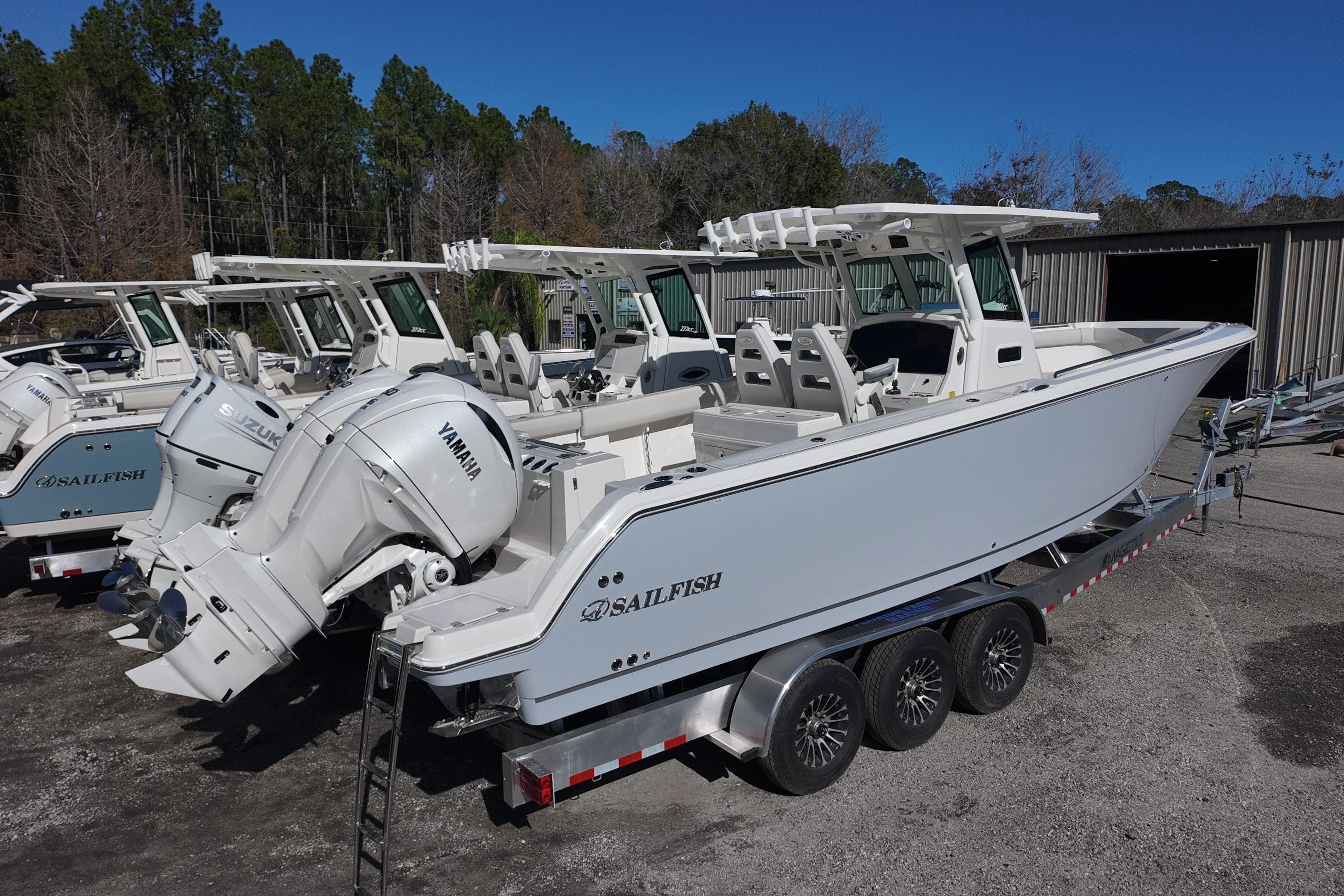 2026 Sailfish 272 CC boat with Yamaha engine on a trailer, parked outdoors.