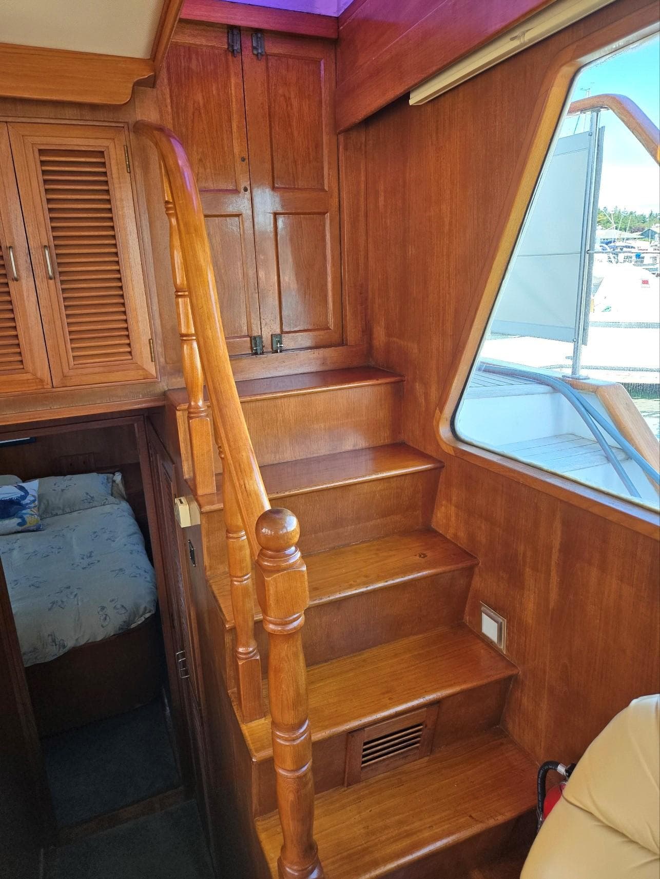 Wooden staircase and cabin interior of 1983 Ocean Alexander 43 Flush Aft Deck yacht.