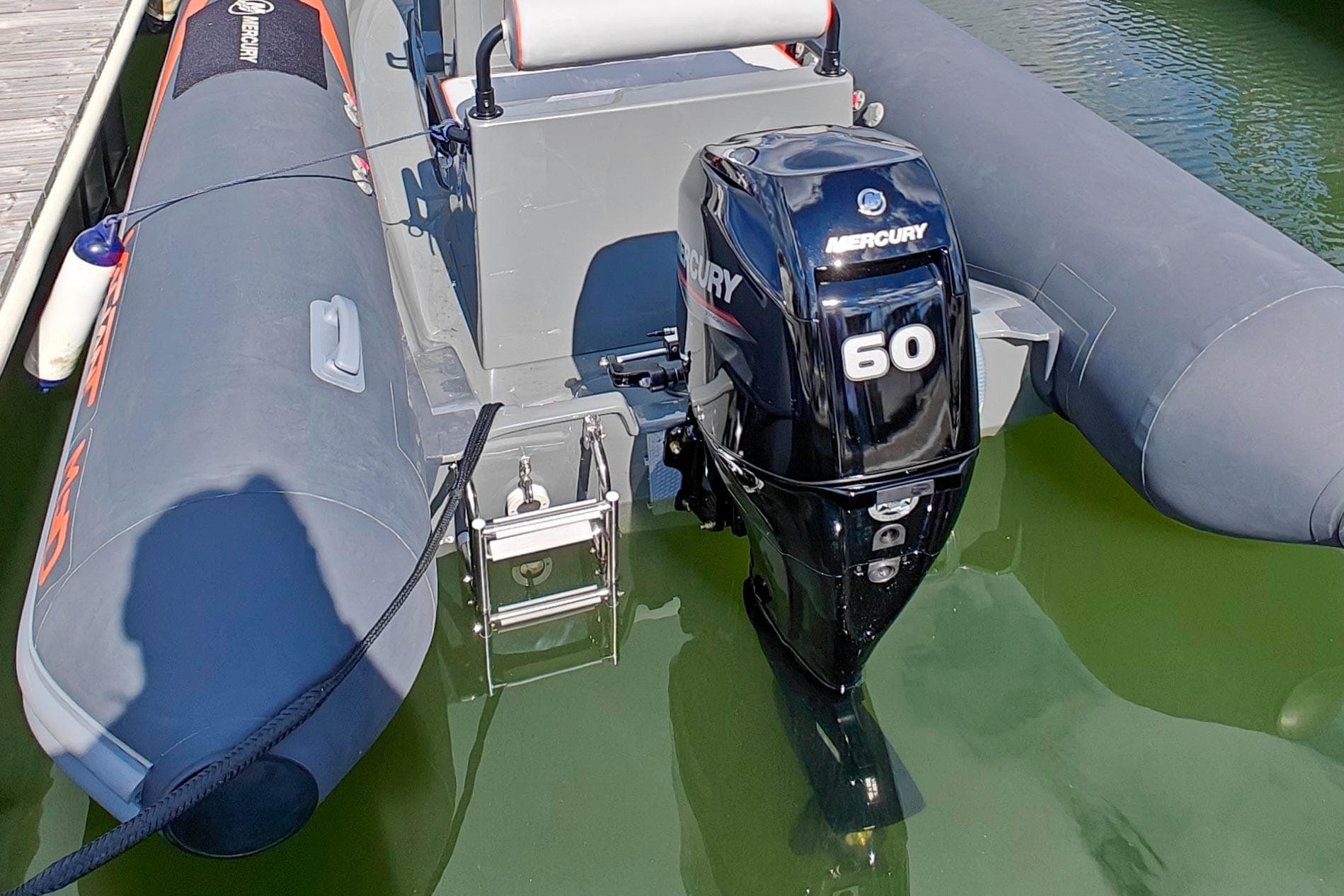 2023 Valiant Med 550 Sport boat with Mercury 60 outboard motor docked in water.