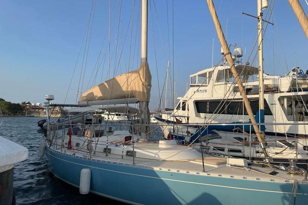 Sailboat "Stevens 47" from 1982 docked at marina, clear sky background.