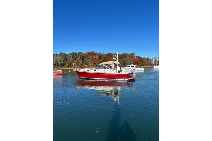 1998 Grand Banks 38 Eastbay EX boat on calm water, clear blue sky.