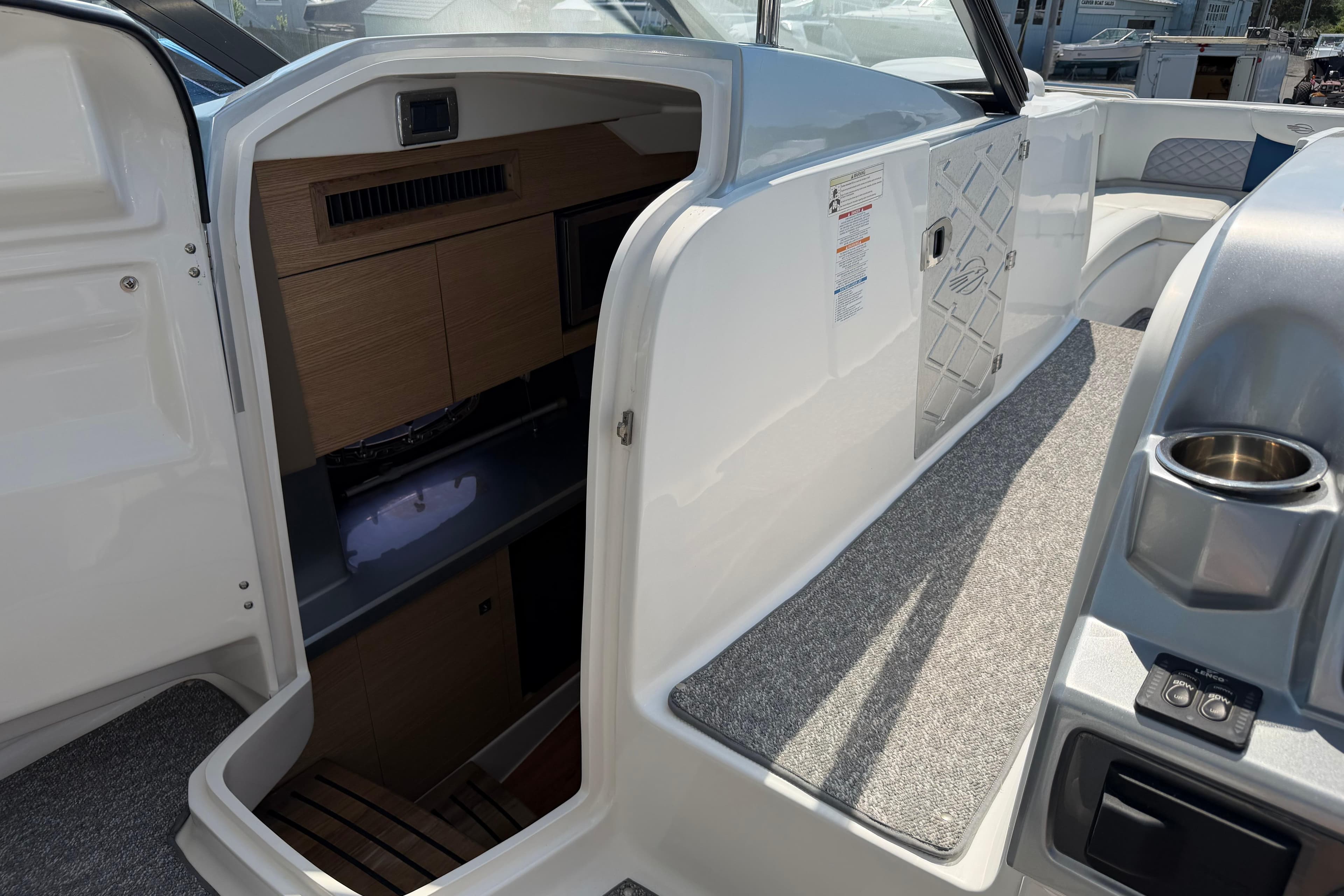 Interior view of 2012 Chaparral 327 SSX boat cabin with seating and storage.