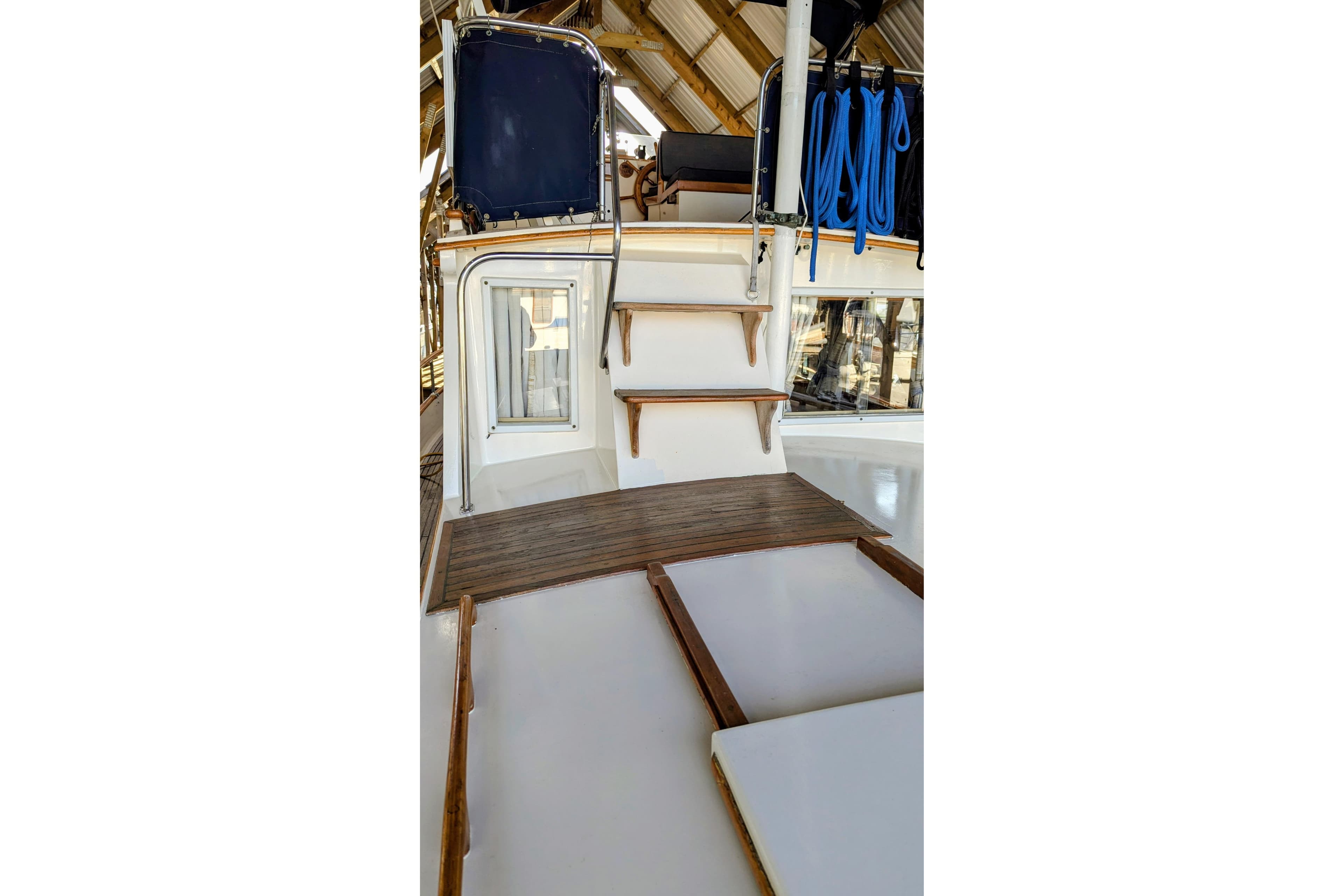 1974 Grand Banks 36 Classic yacht interior with wooden steps and nautical equipment.