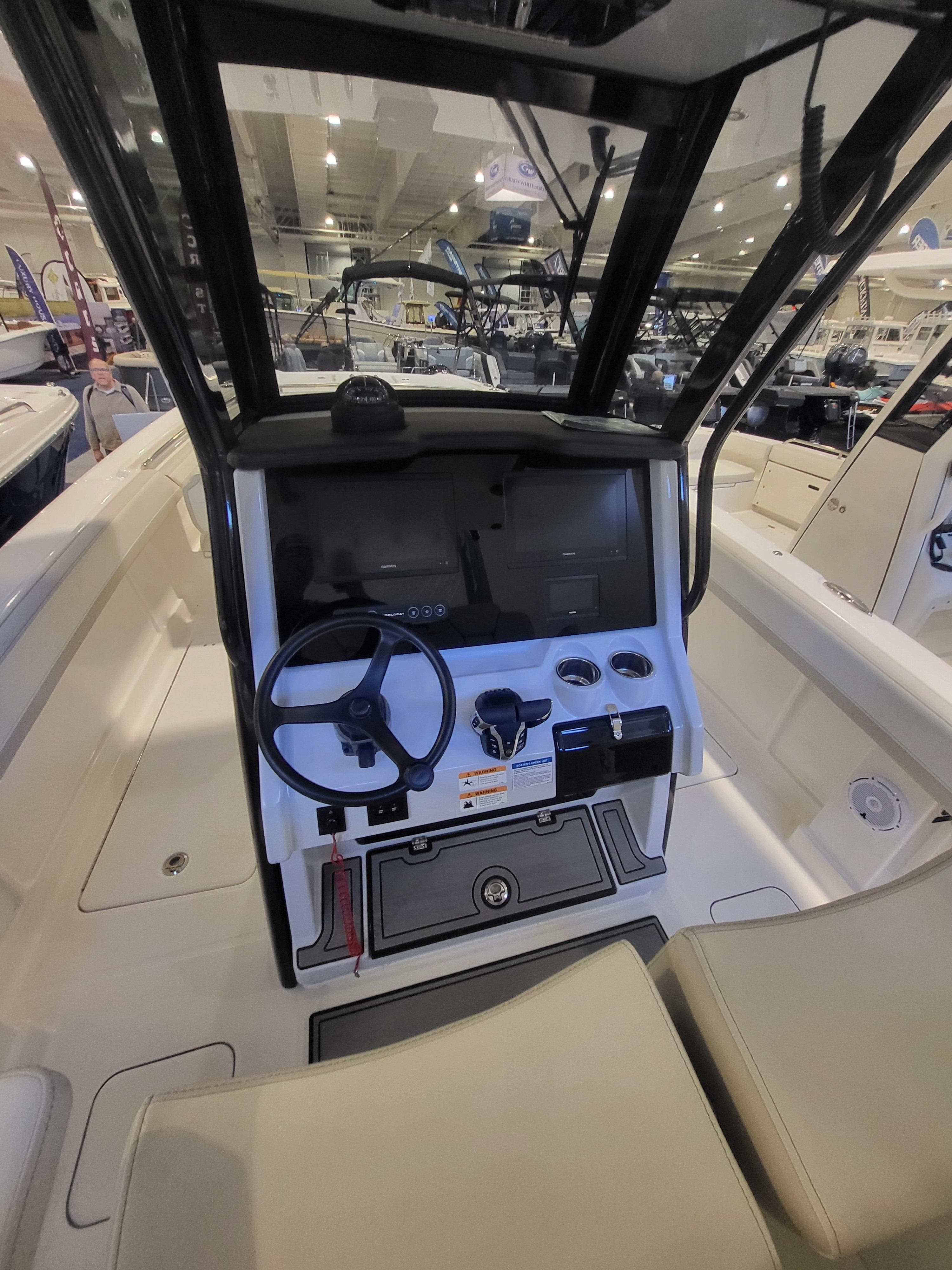 2024 World Cat 280 CC-X boat interior with modern helm and steering wheel.