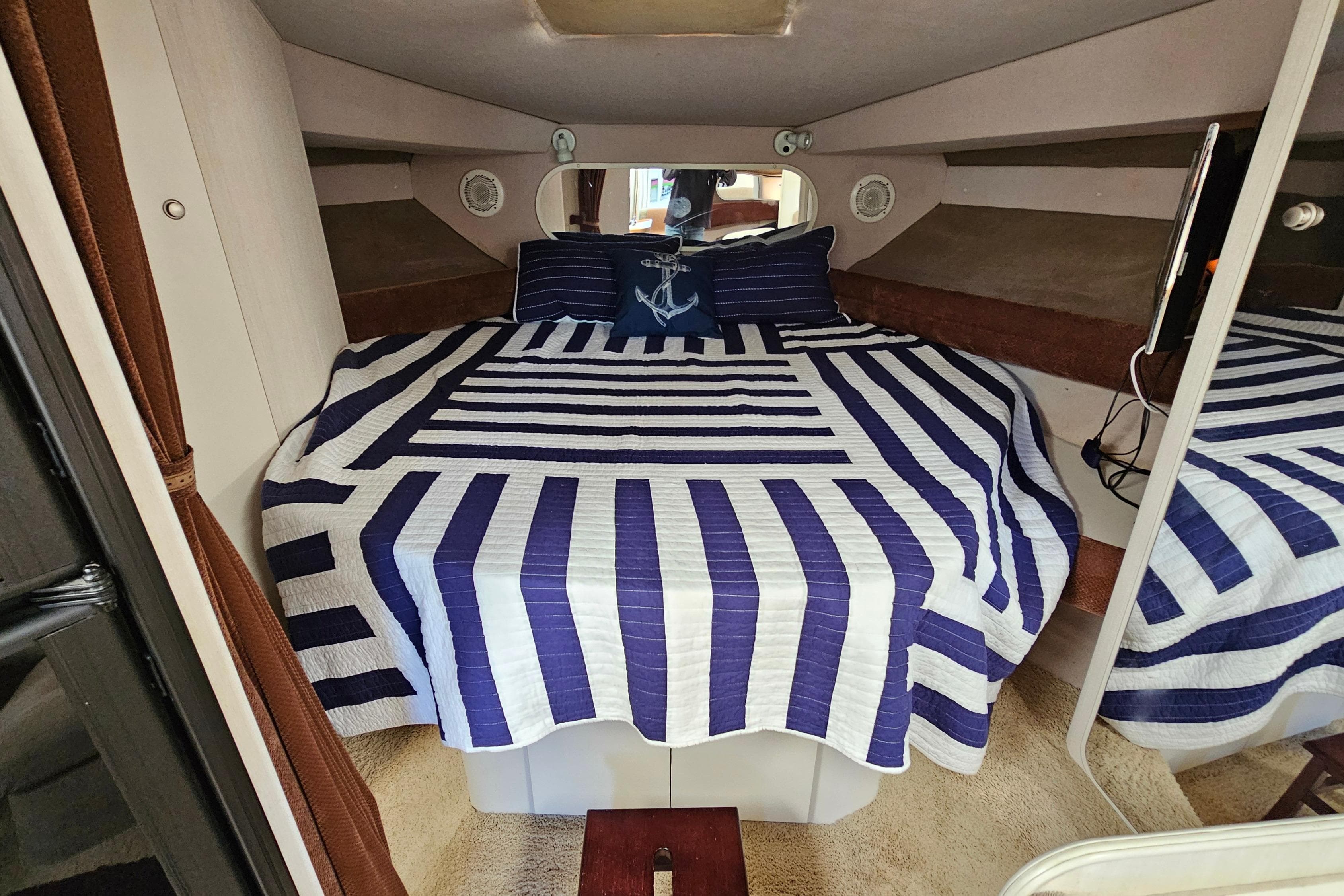 Interior cabin of 1995 Cruisers Yachts 3775 Esprit with striped bedding.