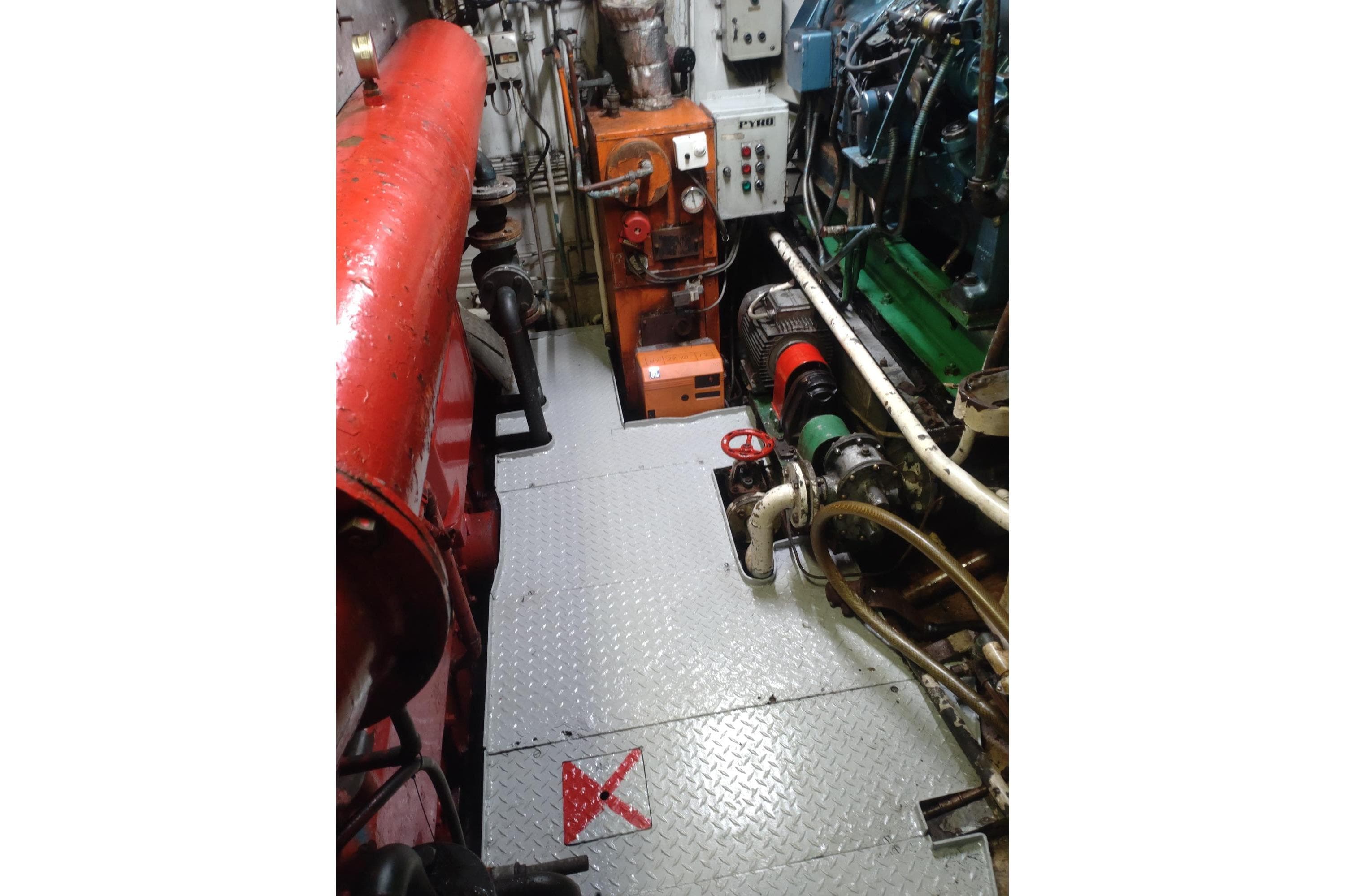 Engine room of a 1967 Custom North Sea Trawler with visible machinery and piping.