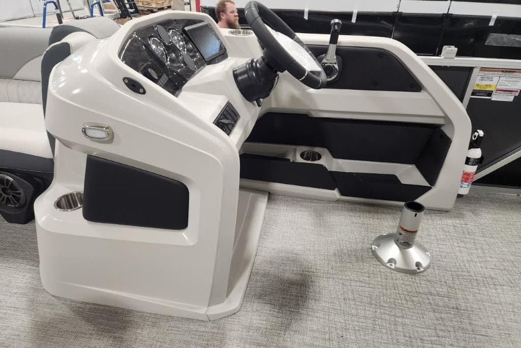 2026 Tahoe Pontoon 1985 LTZ Cruise helm with steering wheel and control panel.