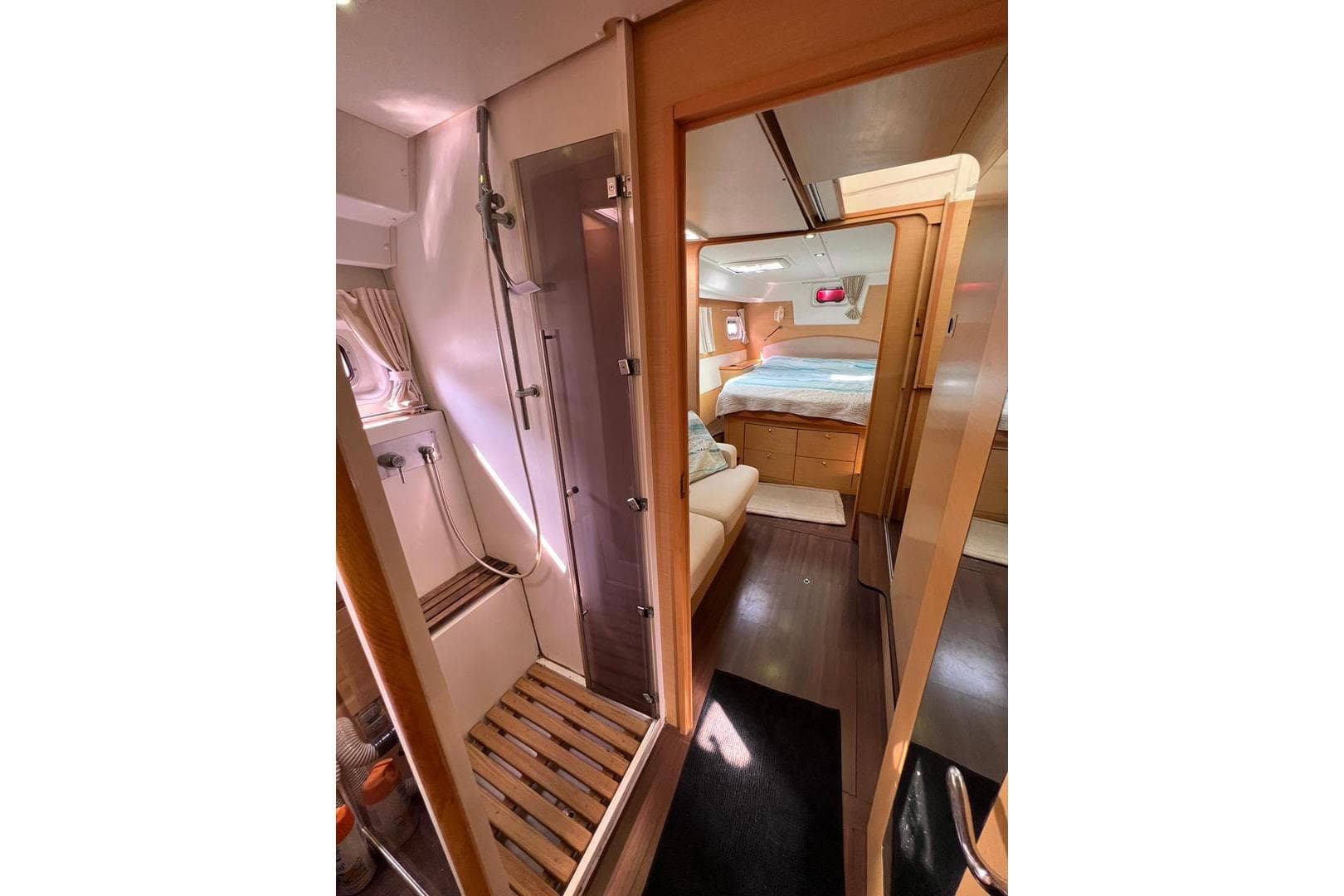 Interior of 2012 Lagoon 500 yacht featuring cozy bedroom and modern shower area.
