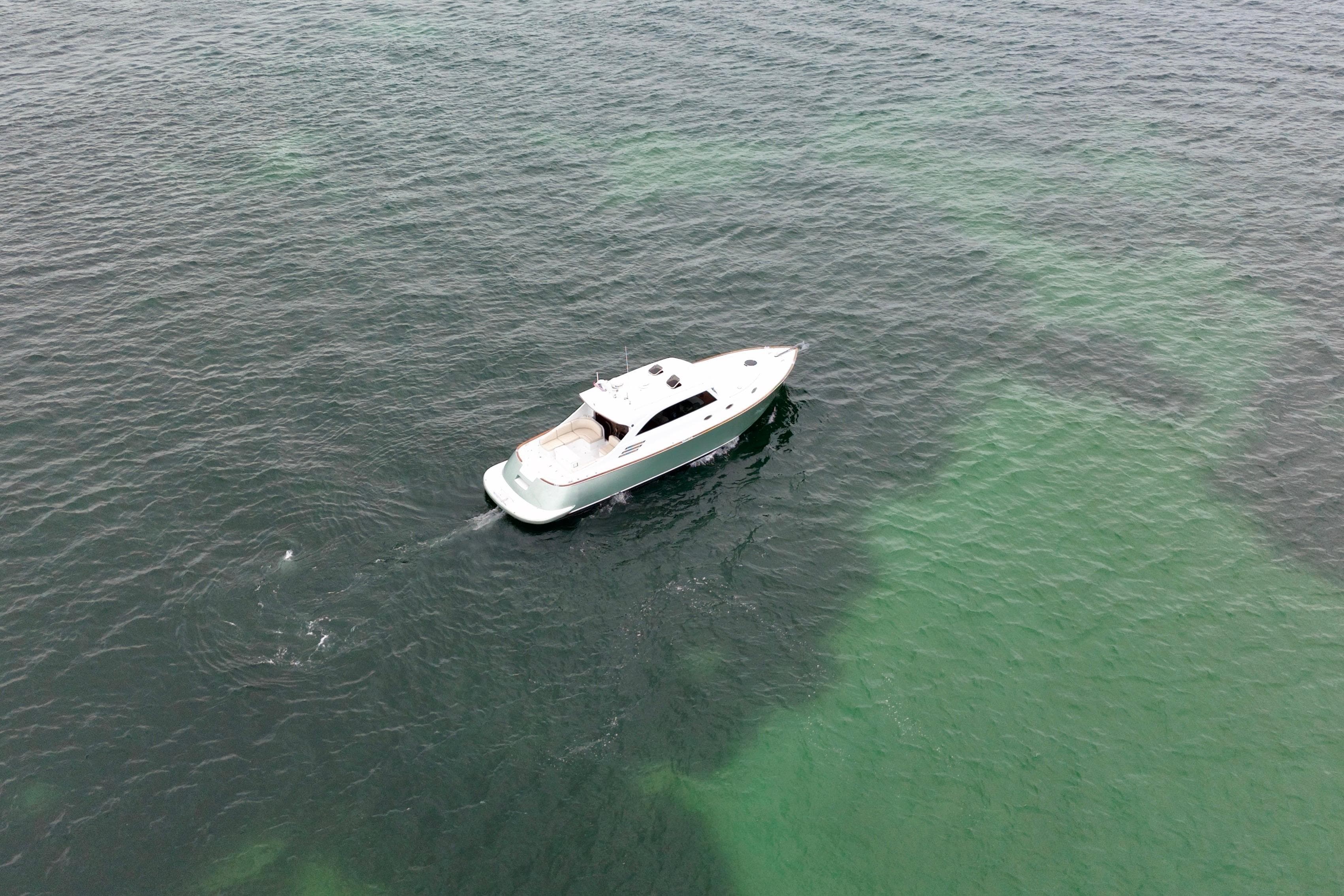 Aerial view of 2008 Limited Edition Soluna 46 yacht cruising on clear ocean waters.