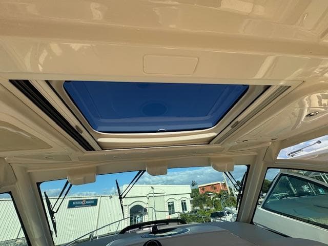 Grady-White Express 370 2021 boat interior with sunroof and clear sky view.