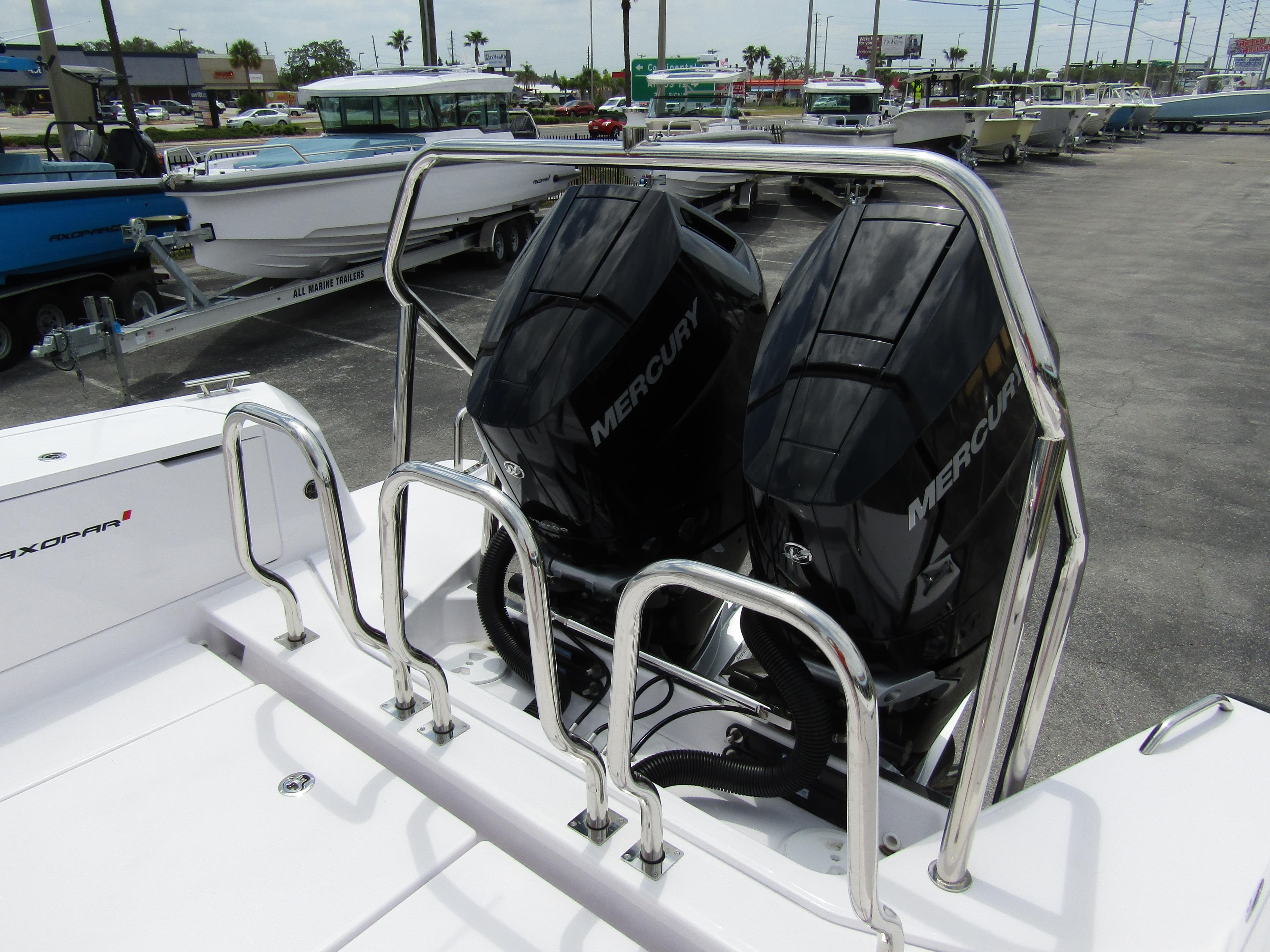2024 Axopar 37 Sun Top with dual Mercury outboard engines, docked in a marina.