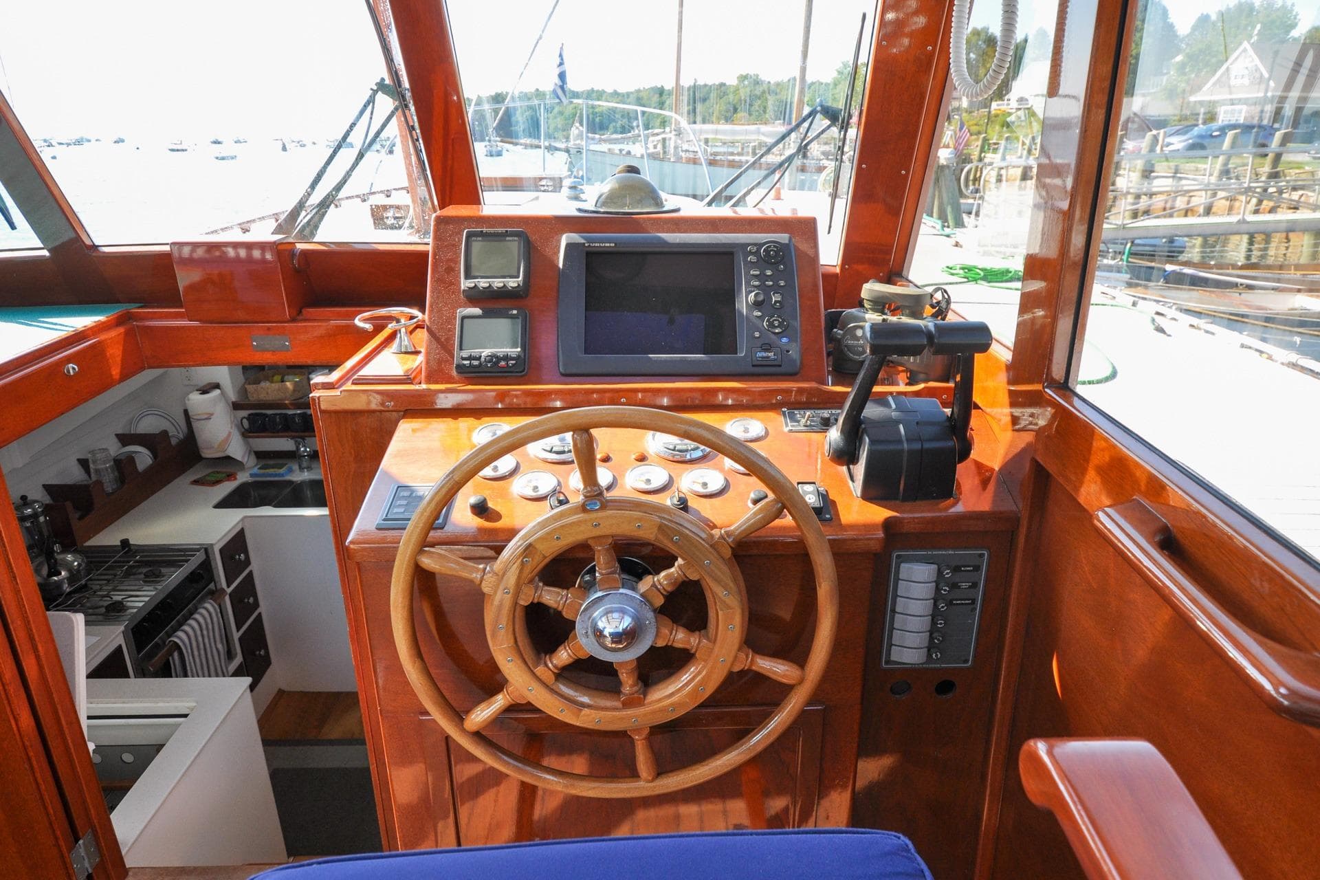 1958 Bunker and Ellis 42 boat helm with wooden wheel and navigation equipment.