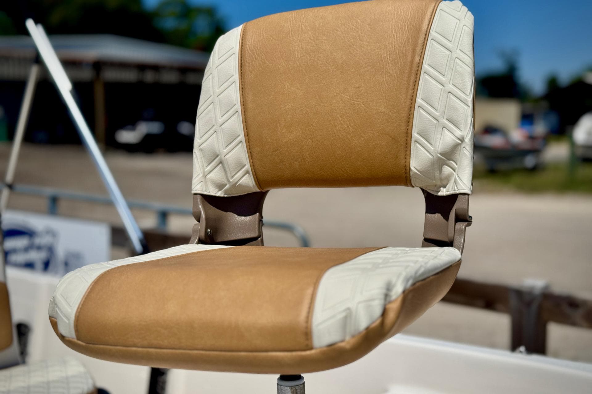 2025 Carolina Skiff 178 JLS boat seat with tan and white upholstery.
