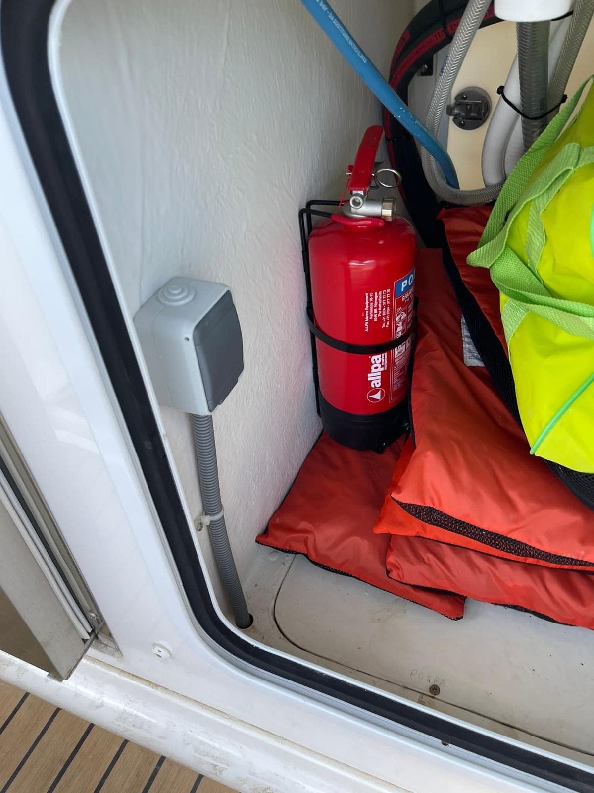 Fire extinguisher and safety gear in 2020 Zar 85 SL boat compartment.