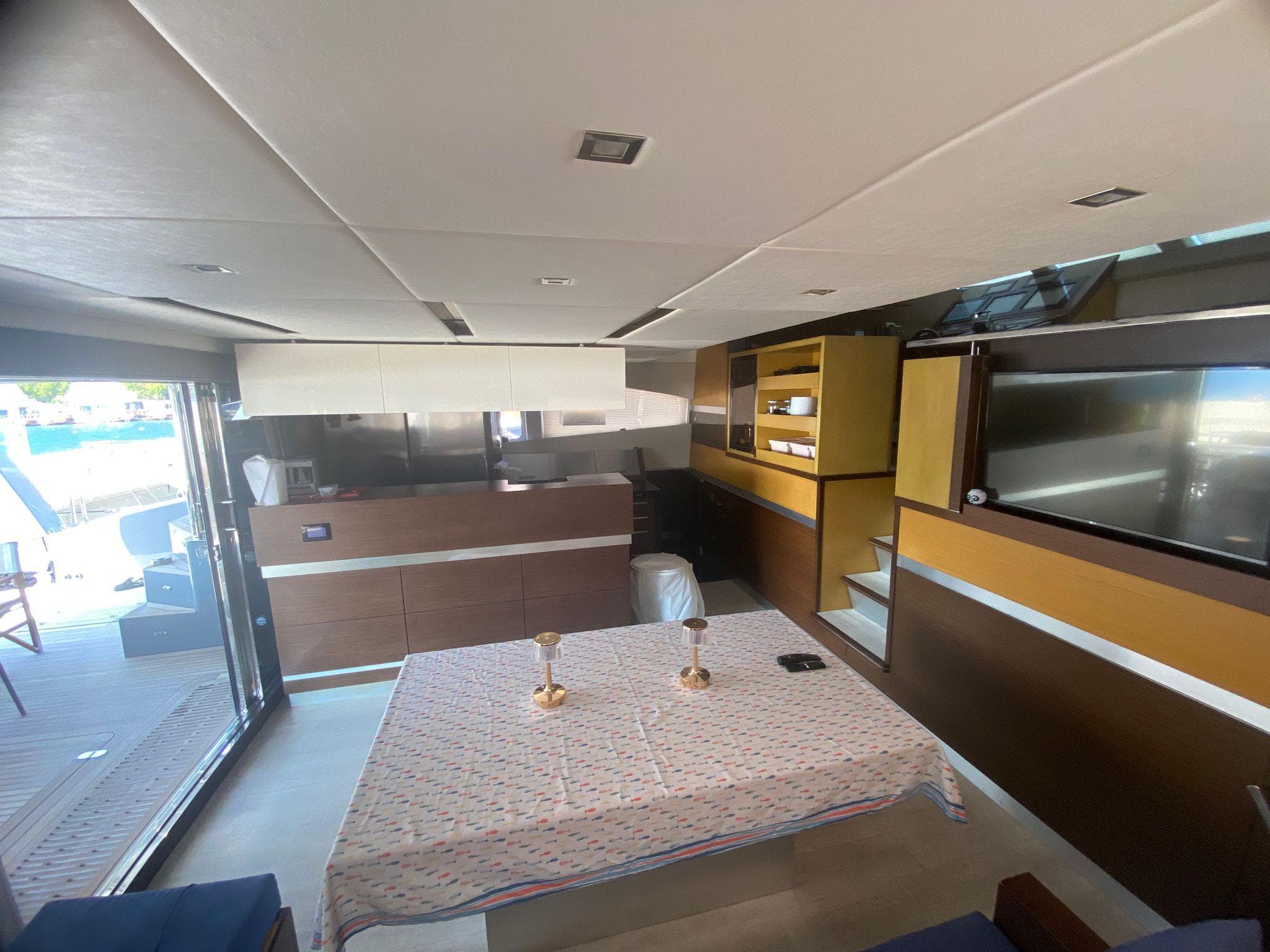 Luxurious interior of a 2012 Sunreef 60 yacht with modern furnishings and elegant dining area.