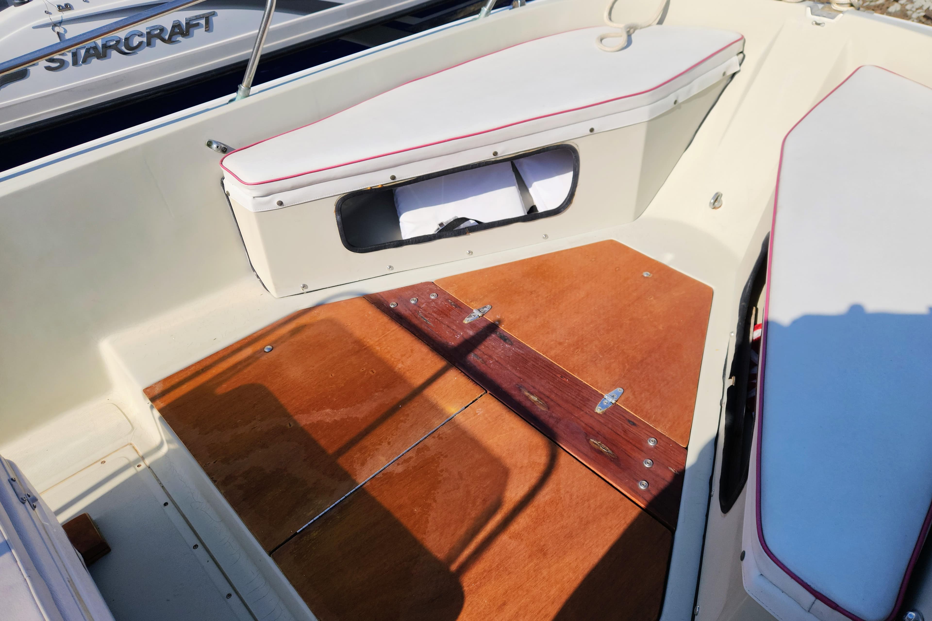 1978 Boston Whaler Outrage 20 interior with wooden deck and cushioned seating.