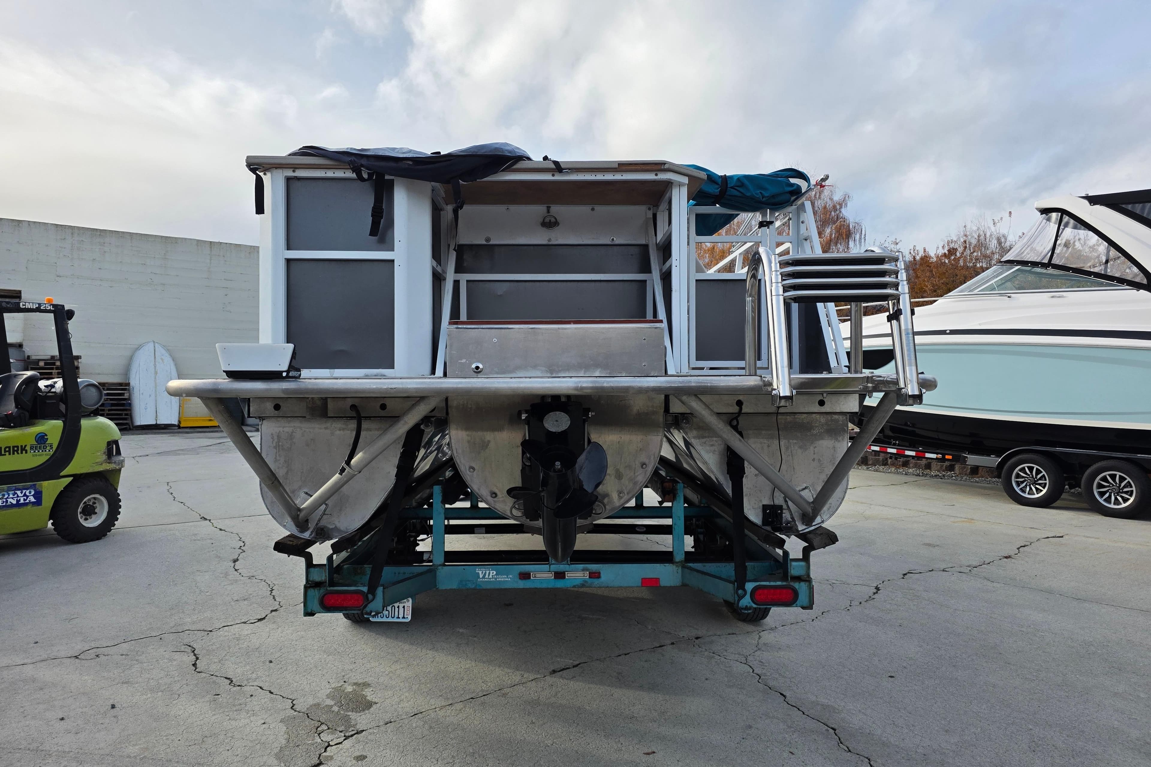 2001 J C Manufacturing TRITOON 226 I/O boat on trailer, rear view.