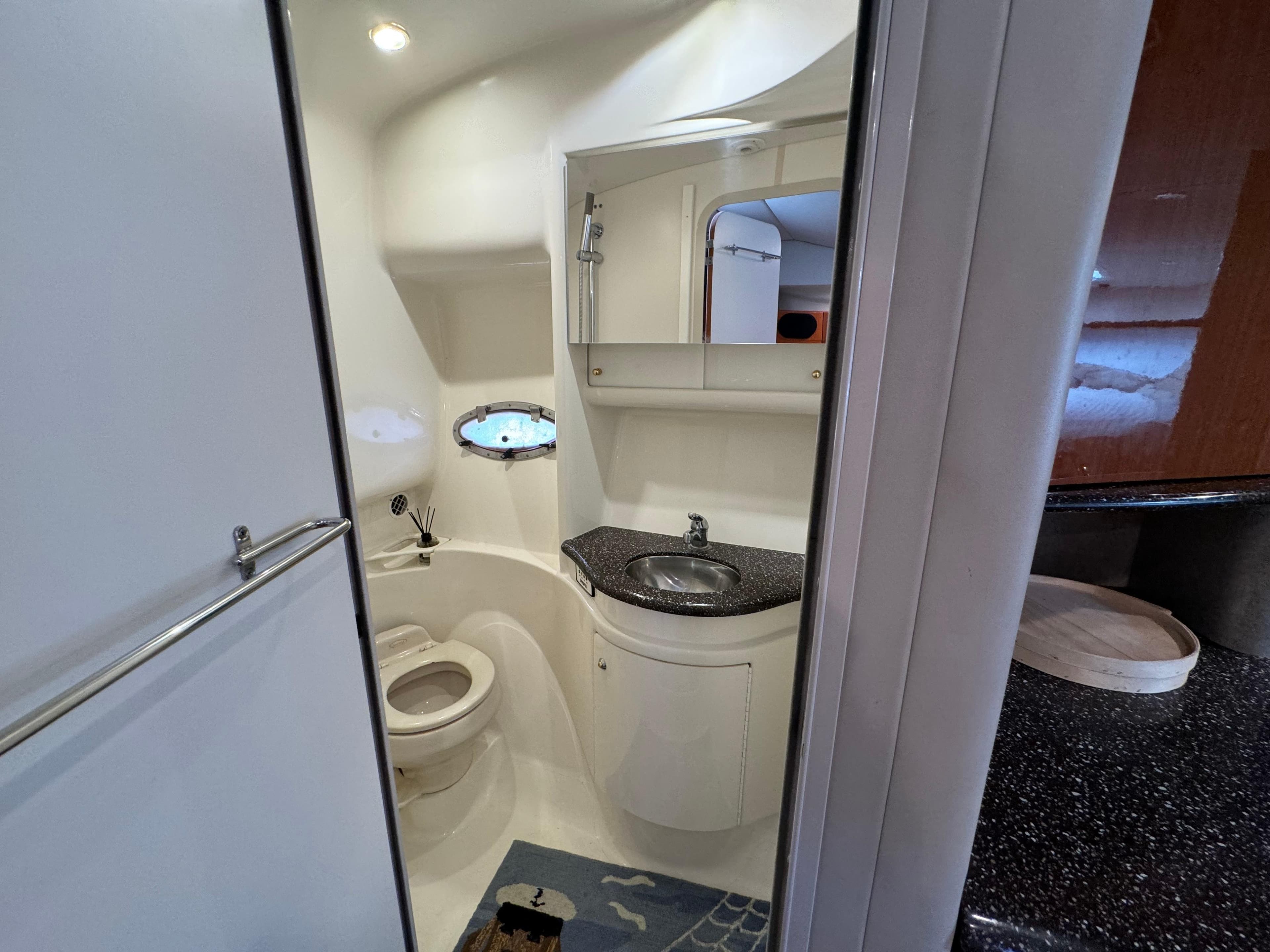 2004 Formula 37 Performance Cruiser bathroom with sink, toilet, and mirror.