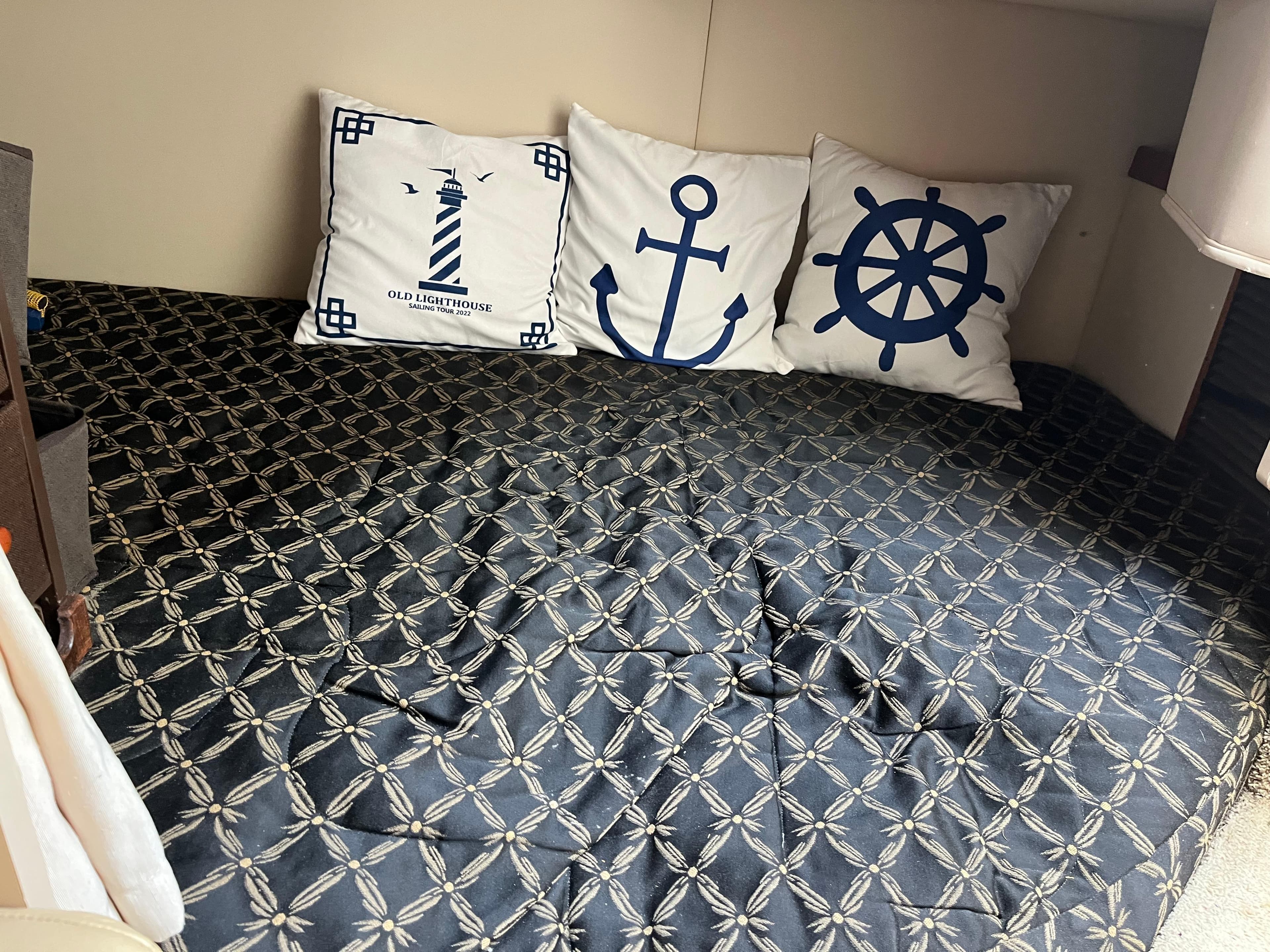 Nautical-themed cabin interior of 2001 Cruisers Yachts 2870 Express with decorative pillows.