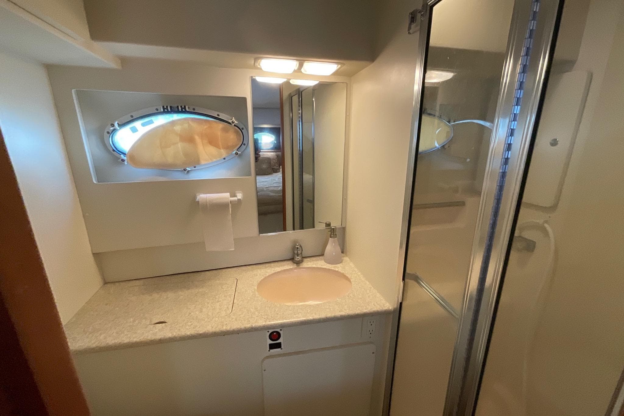 Bathroom interior of 2000 Silverton 392 Motor Yacht with sink and shower.