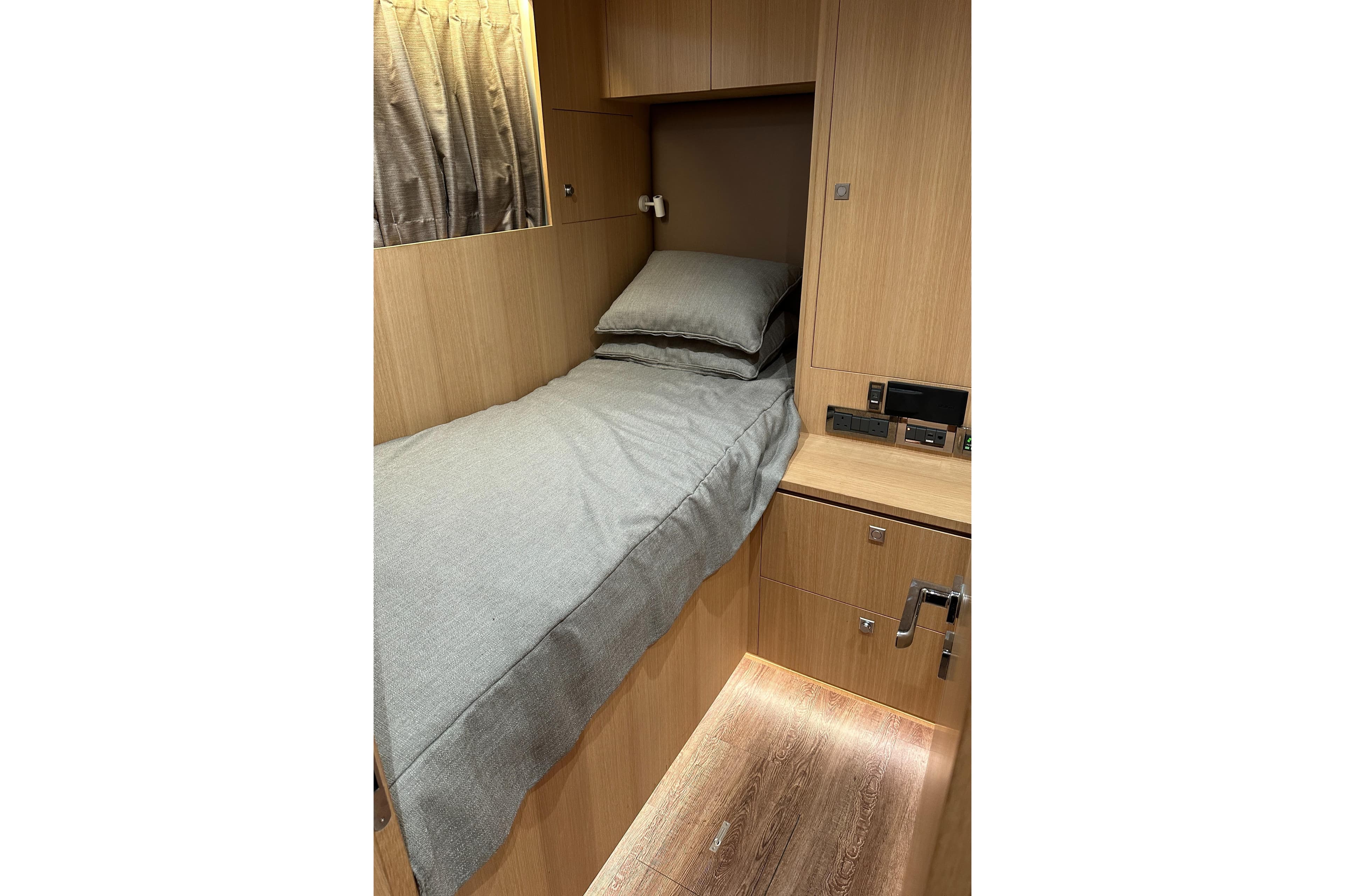 Compact wooden cabin bed in 2021 Horizon FD80 yacht interior.